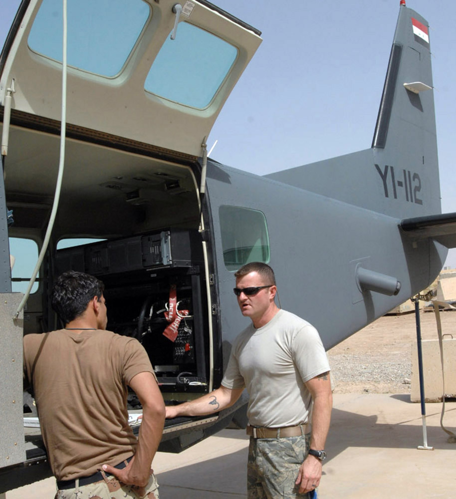 An Iraqi airman reviews technical orders with Master Sgt. Robbie Leist June 7 at Kirkuk Air Base, Iraq. While Iraqi air force pilots continue flying sorties to aid stability in their nation, Iraqi maintainers on the ground have recently achieved important benchmarks to keep their fleet in the air. Airmen with the Iraqi air forces' 3rd Squadron took over a wide variety of maintenance duties on the unit's Cessna intelligence, surveillance and reconnaissance fleet, a task formerly performed by U.S. contractors. Sergeant Leist is with the 870th Expeditionary Air Advisory Squadron. (U.S. Air Force photo/Senior Airman Eric Schloeffel) 