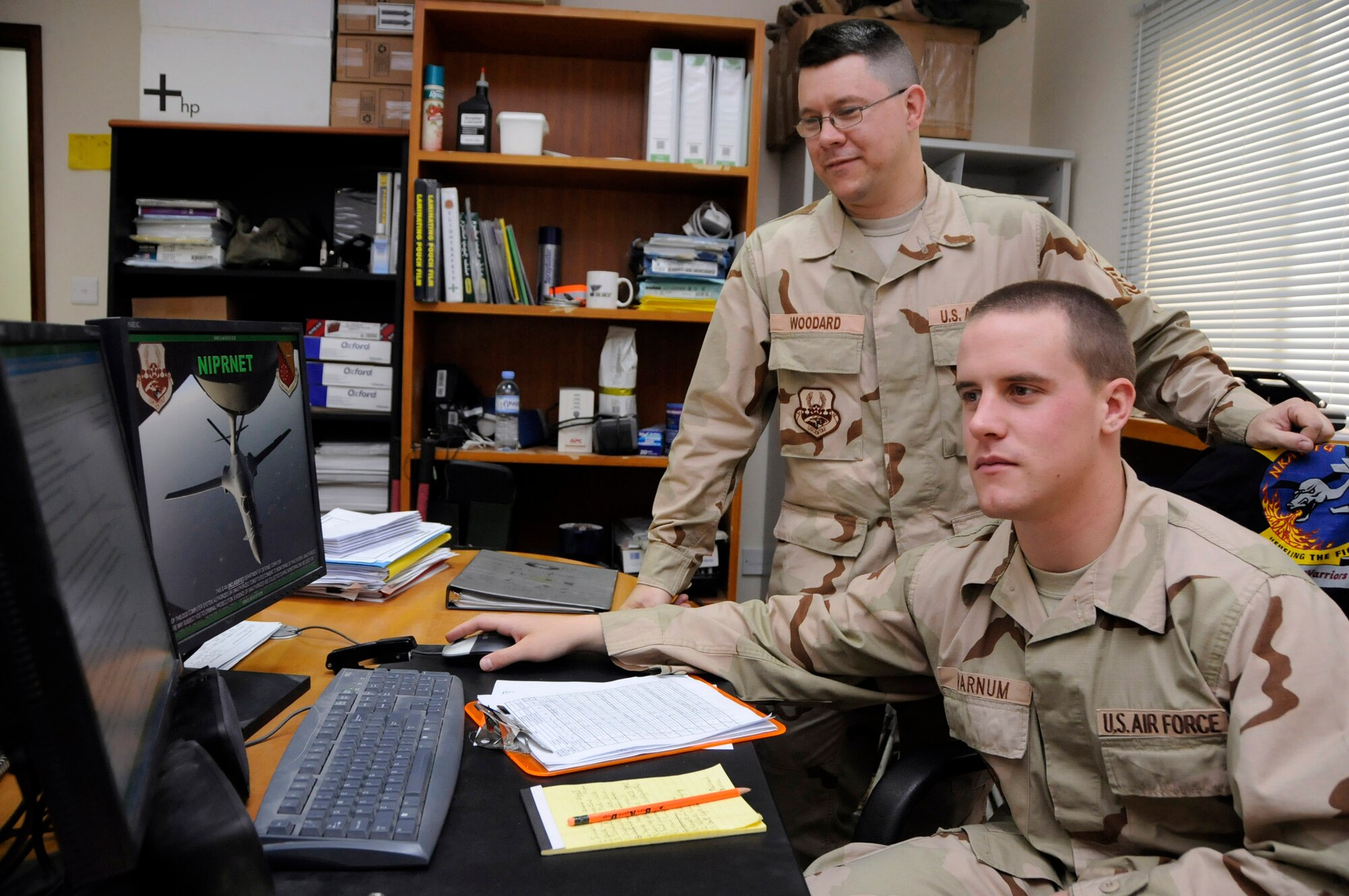 Master Sgt. Brian Woodard instructs Air Force Academy Cadet Nick Varnum on how to complete dorm validations for deployment June 18 at a base in Southwest Asia. Sergeant Woodard is the 340th Expeditionary Air Refueling Squadron first sergeant. The cadets are visiting the base as part of the academy's Operation Air Force program, allowing them to experience an active-duty deployment. (U.S. Air Force photo/Senior Airman Domonique Simmons) 
