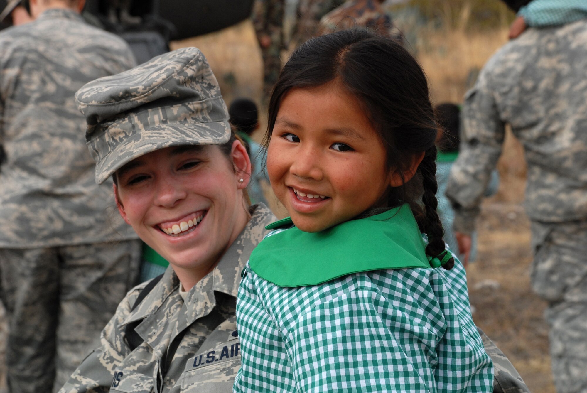 U.S. Air Force Senior Airman Lara Davis, a Personal Support for Contingency Operations (PERSCO) technician deployed from Randolph Air Force Base, Texas, enjoys a laugh with Andrea Leticia Yupari Gozme,4, June 11, during the I.E. Inicial CRL. Miguel Peñarrieta Elementary School’s tour of a U.S. CH-47 Chinook helicopter currently assigned to Task Force New Horizons and residing in Los Cabitos, Peru. (U.S. Air Force photo/Tech. Sgt. Kerry Jackson)