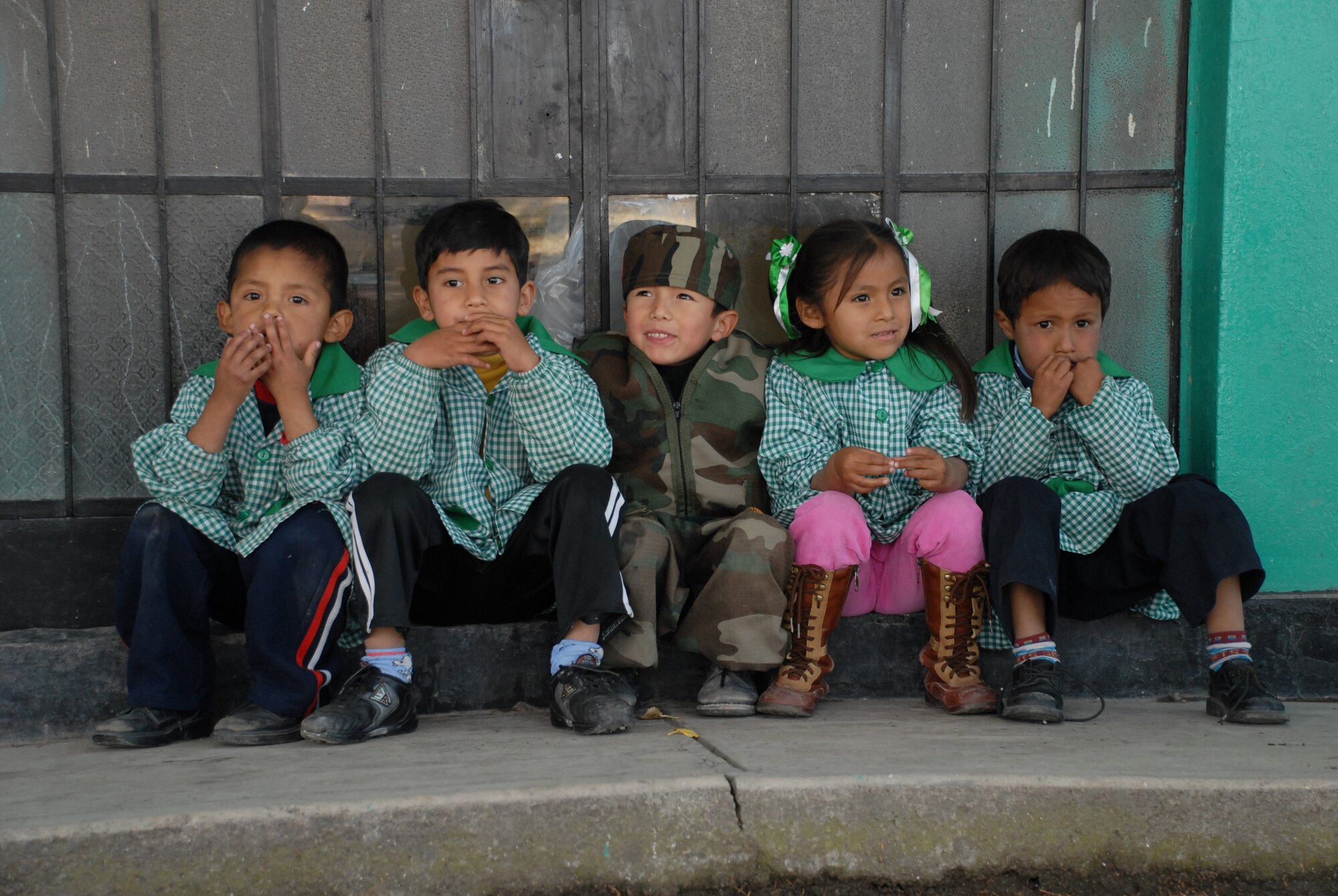 Peruvian children, from I.E. Inicial CRL. Miguel Peñarrieta Elementary School in Los Cabitos, Peru, eagerly await the beginning of recess after their tour of a U.S. CH-47 Chinook helicopter currently assigned to Task Force New Horizons. (U.S. Air Force photo/Airman 1st Class Tracie Forte)