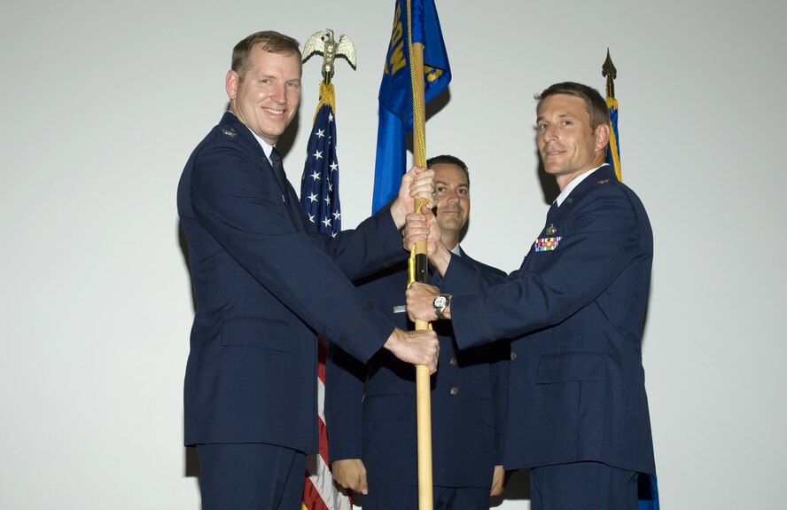 Col. Gary Nelson, 919th Mission Support Group commander, presents the 919th Communications Squadron flag to Maj. Brian Lowmiller during a Change of Command ceremony June 8. Major Lowmiller succeeded Lt. Col. Richard Risner to take command of the squadron. Colonel Risner will move on to work for Air Force Special Operations Command at Hurlburt Field, Fla. (U.S. Air Force Photo/Mike Fleck)