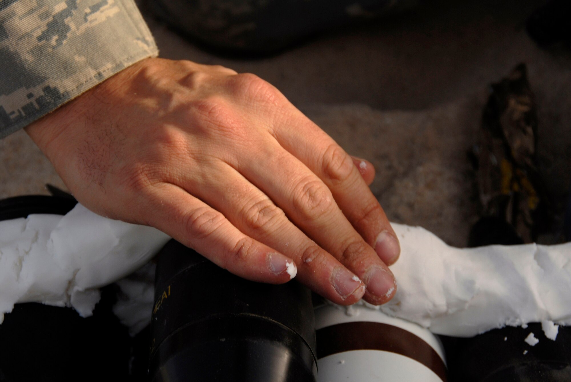 Senior Airman Charles Howell lays down plastic explosive over munitions in preparation for a controlled detonation with coalition forces June 20 at an explosive ordnance disposal range in Southwest Asia. The joint detonation also provided an opportunity for the U.S. and coalition forces to enhance their relations while learning some of the slight differences in operating procedures. Airman Howell is assigned to the 386th Expeditionary Civil Engineer Squadron Explosive Ordnance Disposal Flight. (U.S. Air Force photo/Staff Sgt. Patrick Dixon) 
