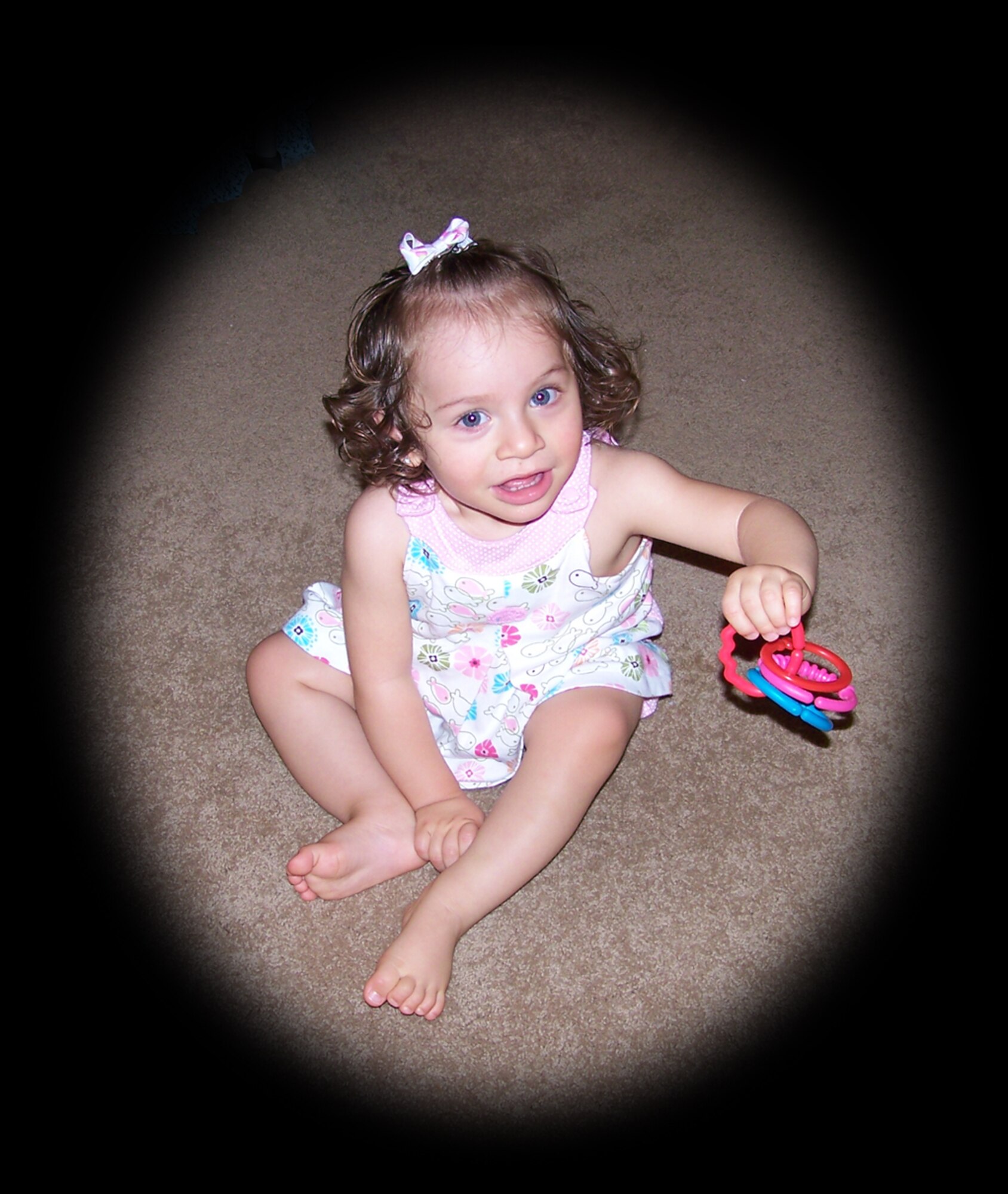 Bella Leyba Lopez plays with a toy on her living room floor. Several wing members participated in a walk-a-thon for the Angelman Syndrome Foundation, May 17, in San Diego, to raise money for research to help children like Bella.