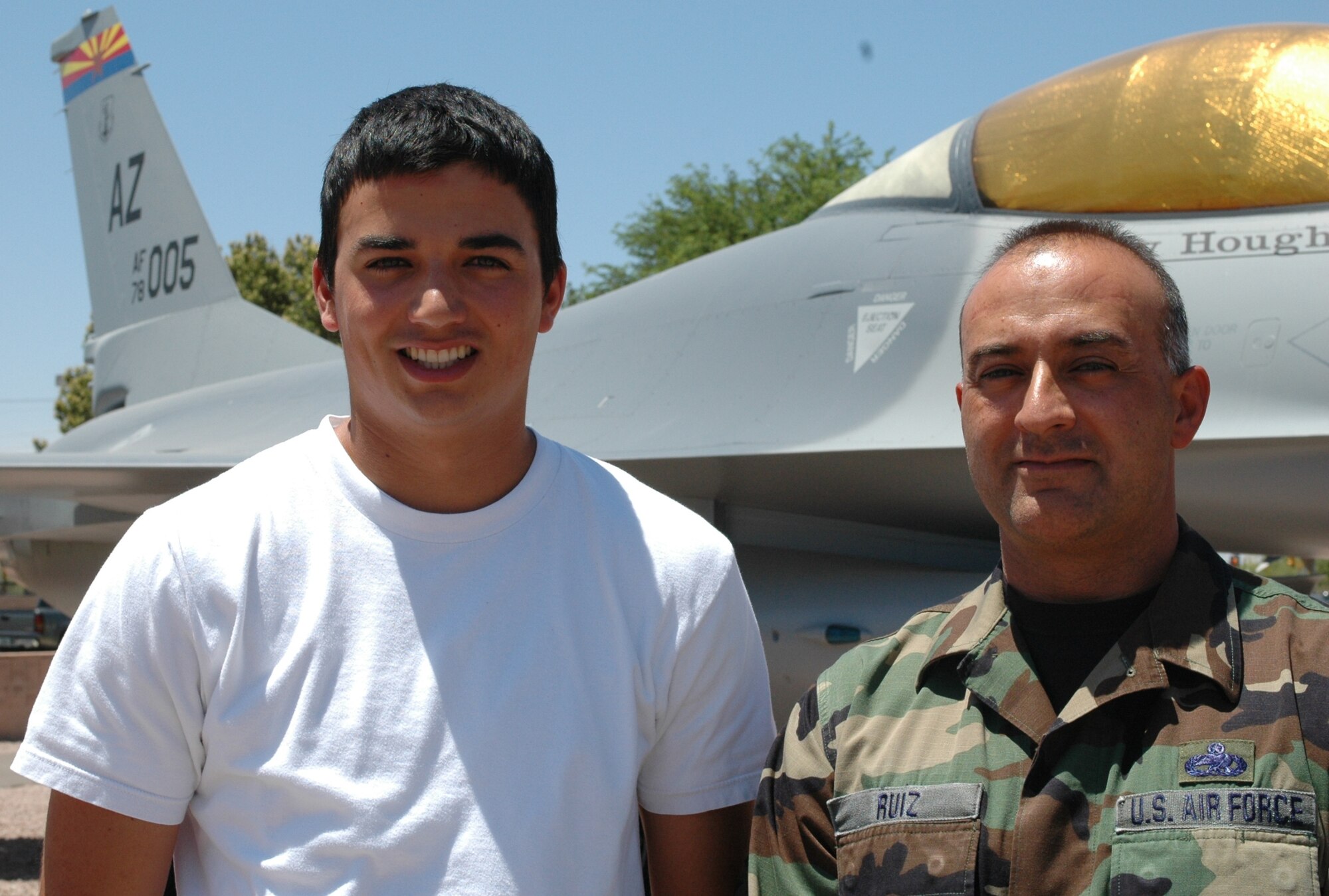 Erik Ruiz and his father, Master Sgt. Ben Ruiz, check out an F-16 static display in the 162nd Fighter Wing air park. Sergeant Ruiz is an avionics technician with 22 years of experience at the wing. Erik is currently a freshman at the Air Force Academy pursuing his dream to become a fighter pilot. (Air National Guard Photo by Capt. Gabe Johnson)