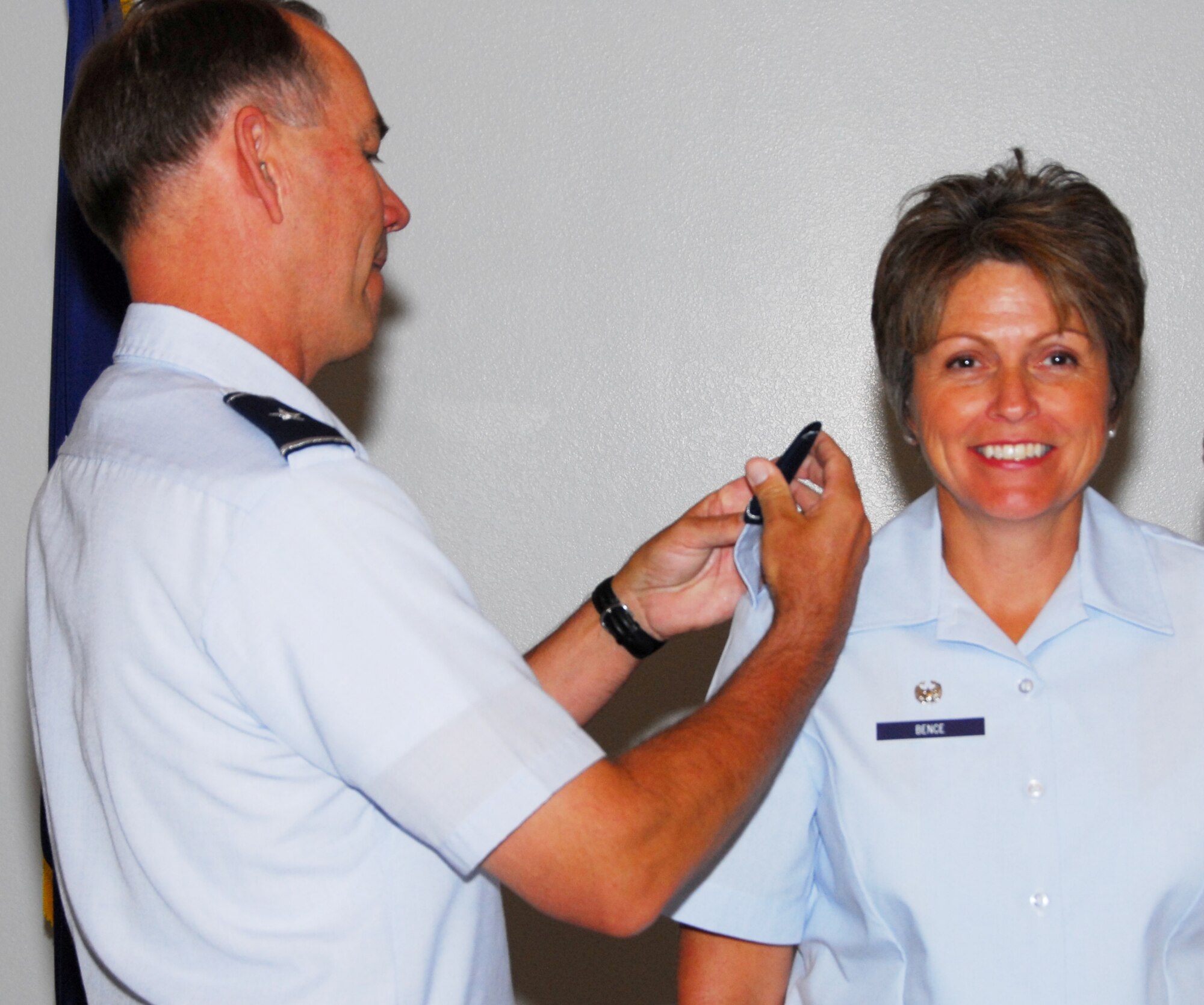 Col. Karen Bence, 162nd Mission Support Group Commander, has her new rank pinned on by Brig. Gen. Rick Moisio, 162nd Fighter Wing commander. The wing’s newest colonel was promoted June 13 in the base dining facility in front of a full house of family, friends and co-workers. According to the colonel, the new rank will serve the 450 Guardsmen that provide diverse support for the largest full-time force in the Air Naitonal Guard. (Air National guard photo by Master Sgt. Dave Neve)