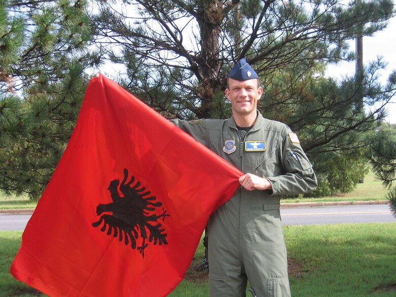 Lt Col Mark Synovitz, Air Mobility Command Air Operations Squadron Detachment 2 commander, displays the homemade Kosovo flag passed along to him from Tony, a Kosovo refugee during Operation Allied Force in 1999. (U.S. Air Force/Judi Brown)