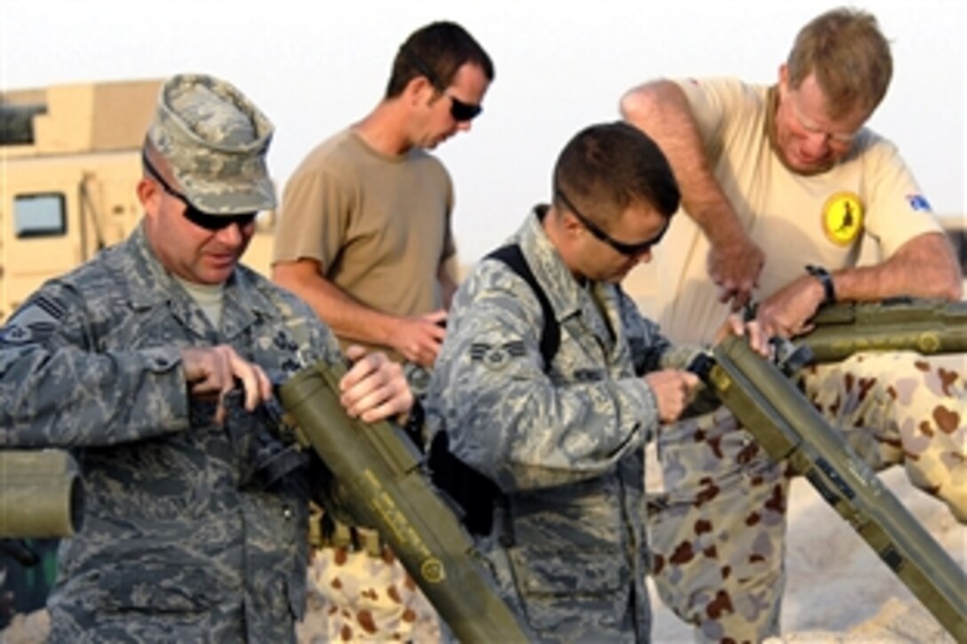 Members of the U.S. Air Force 386th Expeditionary Civil Engineer Squadron and Australian army ammunition technicians prepare anti-armor weapon rockets for disposal before a controlled detonation, June 20, 2008, at a range in Southwest Asia, June 20, 2008. 