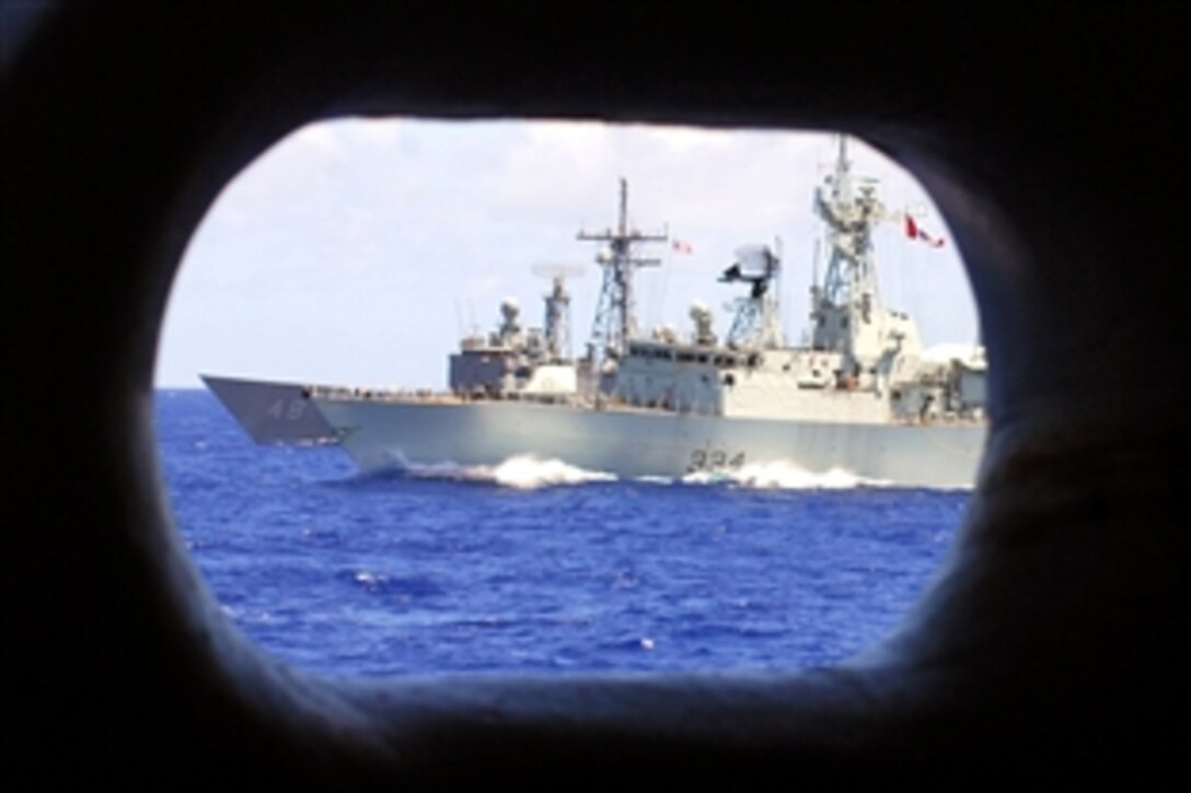 The Canadian Navy frigate HMCS Regina, front, and the frigate USS Vandegrift sail on the starboard side of the aircraft carrier USS Kitty Hawk, Pacific Ocean, June 23, 2008. The USS Kitty Hawk is returning to the United States for decommissioning after 47 years of service.