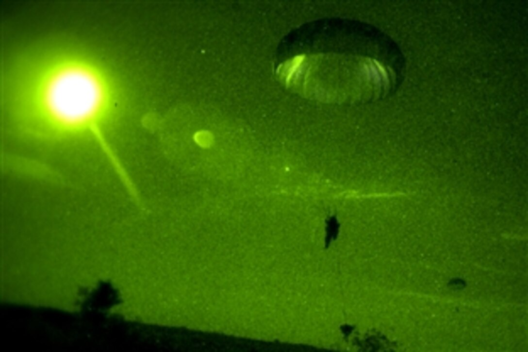 As seen through night vision gear, U.S. soldiers parachute at night from a U.S. Air Force C-130 Hercules aircraft during a joint forcible entry exercise on Fort Bragg, N.C., June 17, 2008. The soldiers are assigned to 305th Parachute Infantry Regiment, 82nd Airborne Division.