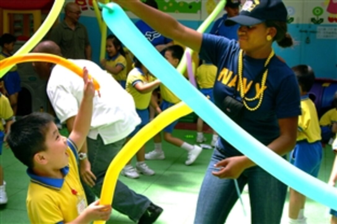 U.S. Navy Seaman Nicole Blanks plays with a local kindergartner at the Hong Kong Society for the Protection of Children Wai Yin Club Nursery School, Hong Kong, June 20, 2008. During the community relations projects, 25 USS Decatur crewmembers entertained local children for two hours at a government-supported nursery for lower-income families. 
