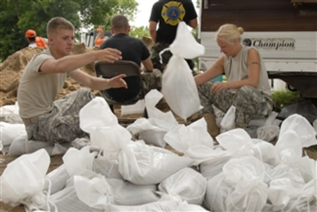 U.S. Army Pfc. Justin Lehmkuhl, from 631 Engineer Company, and Sgt. Kelly Keeven, from the 1344 Transportation Company, help tie sandbags at New Canton, Ill., in support of Mississippi Response on June 19, 2008.  Iowa National Guard airmen and soldiers have been activated to work with state and local agencies to provide security and help recover areas damaged by widespread flooding.  