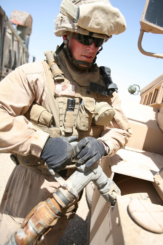 Sgt. Barnaby E. Yoder, a motor transport operator for Task Force Hit, 3rd Battalion, 4th Marine Regiment, Regimental Combat Team 5, refuels a Mine Resistant Ambush Protected vehicle during a resupply mission in western Al Anbar province, Iraq, July 1. Marines with Motor T have been logging in long hours and traveling great distances to help 3rd Battalion, 4th Marines complete its missions. Motor T has assisted the battalion with anything from resupplying combat outposts to providing companies with ice and water.::r::::n::::r::::n::