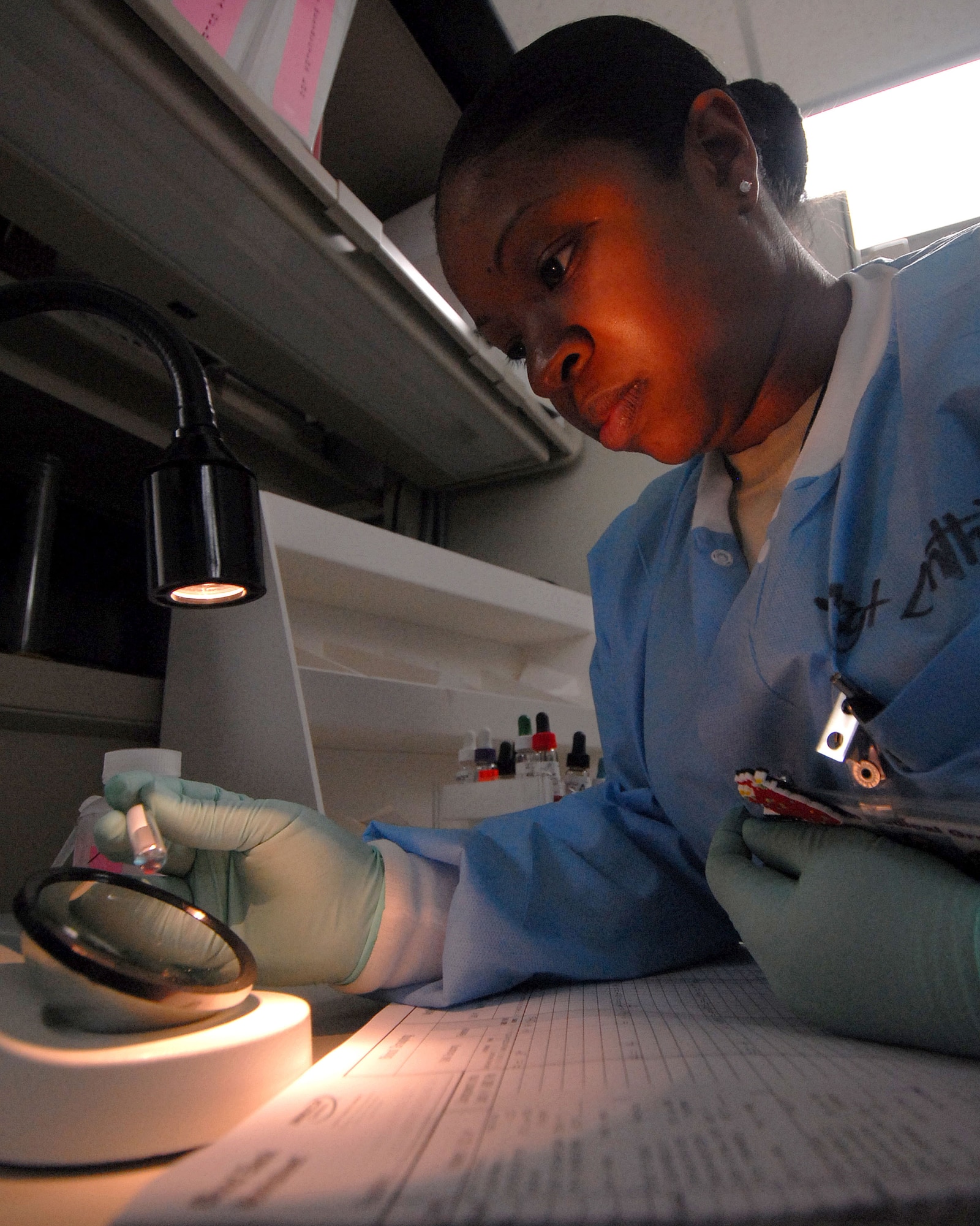 YOKOTA AIR BASE, Japan -- Technical Sergeant Symone Linthicome from the 374th Medical Group, observers for clotting in a blood sample. This is one of many steps in the ABO grouping process (U.S. Air Force photo by Senior Airman Laszlo Babocsi)