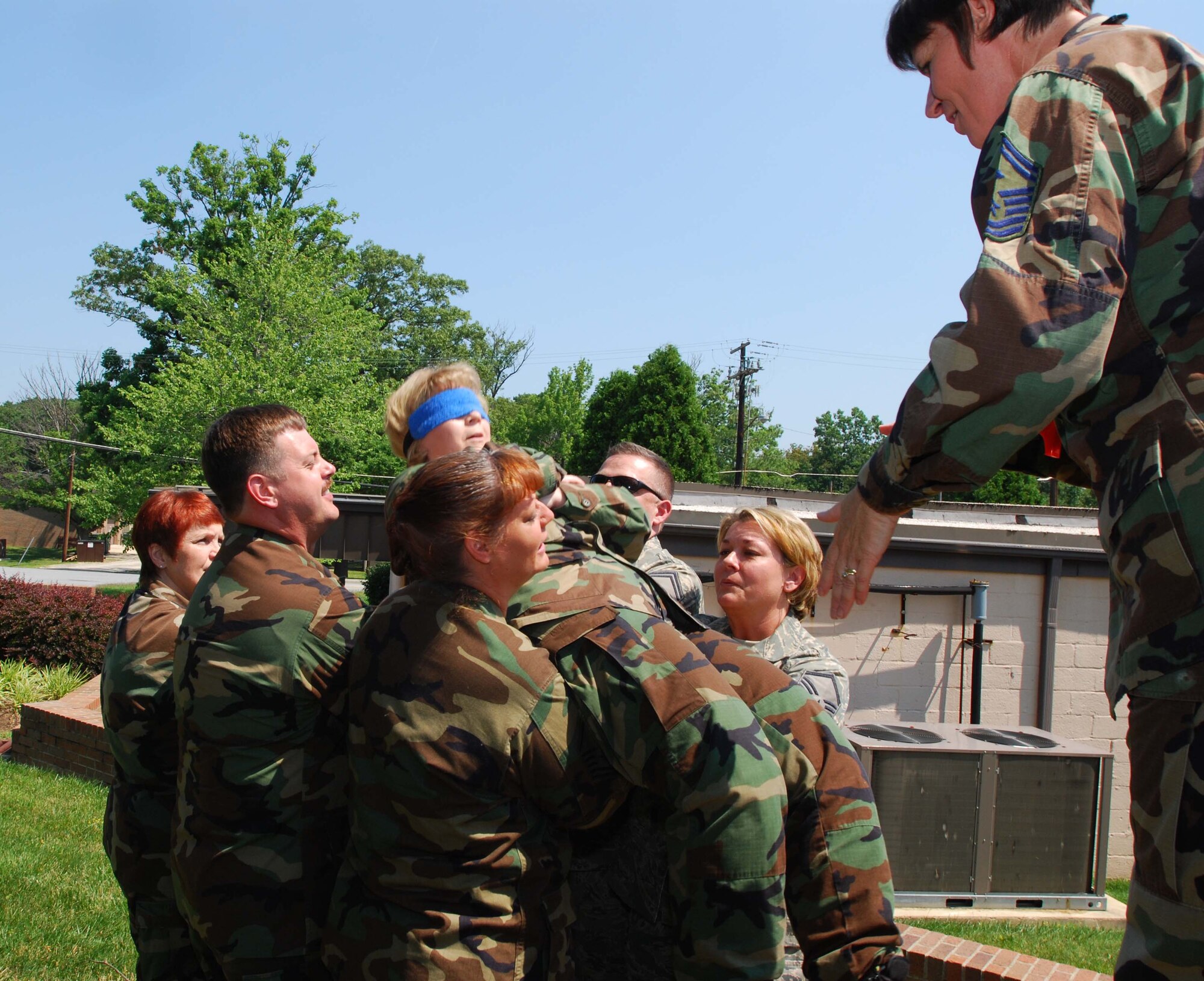 ANDREWS AIR FORCE BASE, Md. -- Senior Master Sgt. Sonja Kelley-Owens, 459th Mission Support Flight, braces as facilitator Senior Master Sgt. Sandra Dye, 72nd Air Refueling Squadron first sergeant from Grissom Air Reserve Base, Ind., releases her from a blindfolded freefall into the arms of her fellow classmates during the Air Force Reserve Command Senior Non-Commissioned Officer Leadership Course here June 21. The interactive two-day course consisted of group discussions, trust exercises, and techniques to enhance communication with commanders and subordinates. (U.S. Air Force photo/Tech. Sgt. Amaani Lyle)