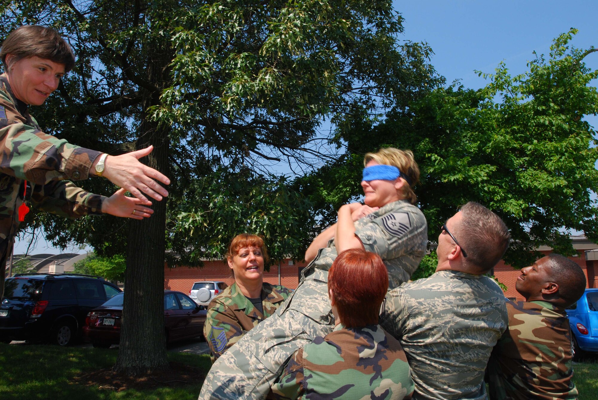 ANDREWS AIR FORCE BASE, Md. -- Senior Master Sgt. Sandra Dye, 72nd Air Refueling Squadron first sergeant from Grissom Air Reserve Base, Ind., releases a student from a blindfolded freefall into the arms of her fellow classmates during the Air Force Reserve Command Senior Non-Commissioned Officer Leadership Course here June 21. The interactive two-day course consisted of group discussions, trust exercises, and techniques to enhance communication with commanders and subordinates. (U.S. Air Force photo/Tech. Sgt. Amaani Lyle)