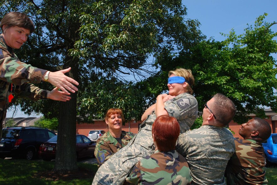 ANDREWS AIR FORCE BASE, Md. -- Senior Master Sgt. Sandra Dye, 72nd Air Refueling Squadron first sergeant from Grissom Air Reserve Base, Ind., releases a student from a blindfolded freefall into the arms of her fellow classmates during the Air Force Reserve Command Senior Non-Commissioned Officer Leadership Course here June 21. The interactive two-day course consisted of group discussions, trust exercises, and techniques to enhance communication with commanders and subordinates. (U.S. Air Force photo/Tech. Sgt. Amaani Lyle)