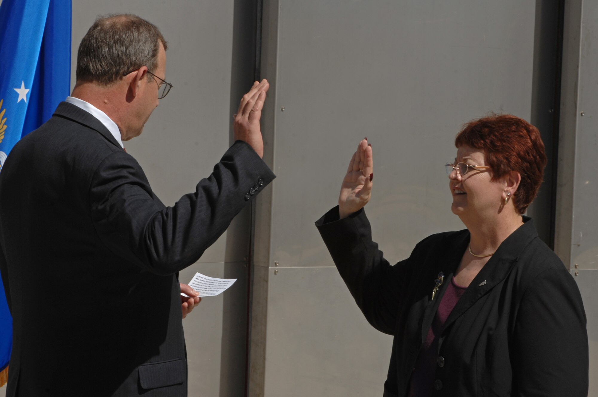 Joan Causey, Air Force Financial Services director, is sworn into the ranks of the Senior Executive Service by Richard Gustafson, Air Force Financial Operations deputy assistant secretary, at Mount Rushmore, June 24. Ms. Causey oversees military pay and travel reimbursements for all Air Force active-duty, civilian and Reserve personnel.  (U.S. Air Force photo/Airman Corey Hook)