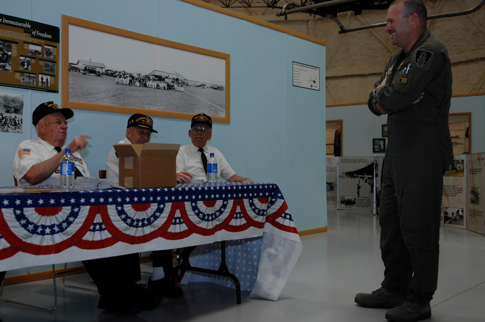 (left to right) Korean War veterans Al Skidmore, retired  Lt. Col. Jerry Teachout and retired Army Sgt. 1st Class Alvin Glensmann hold a discussion with Maj. Robert Liebman, 28th Bomb Wing Command Post officer in charge, on their Korean War experiences at the South Dakota Air and Space Museum June 25. The display commemorated the 58th anniversary of the beginning of hostilities in Korea. (U.S. Air Force photo/Airman Matthew Flynn)
