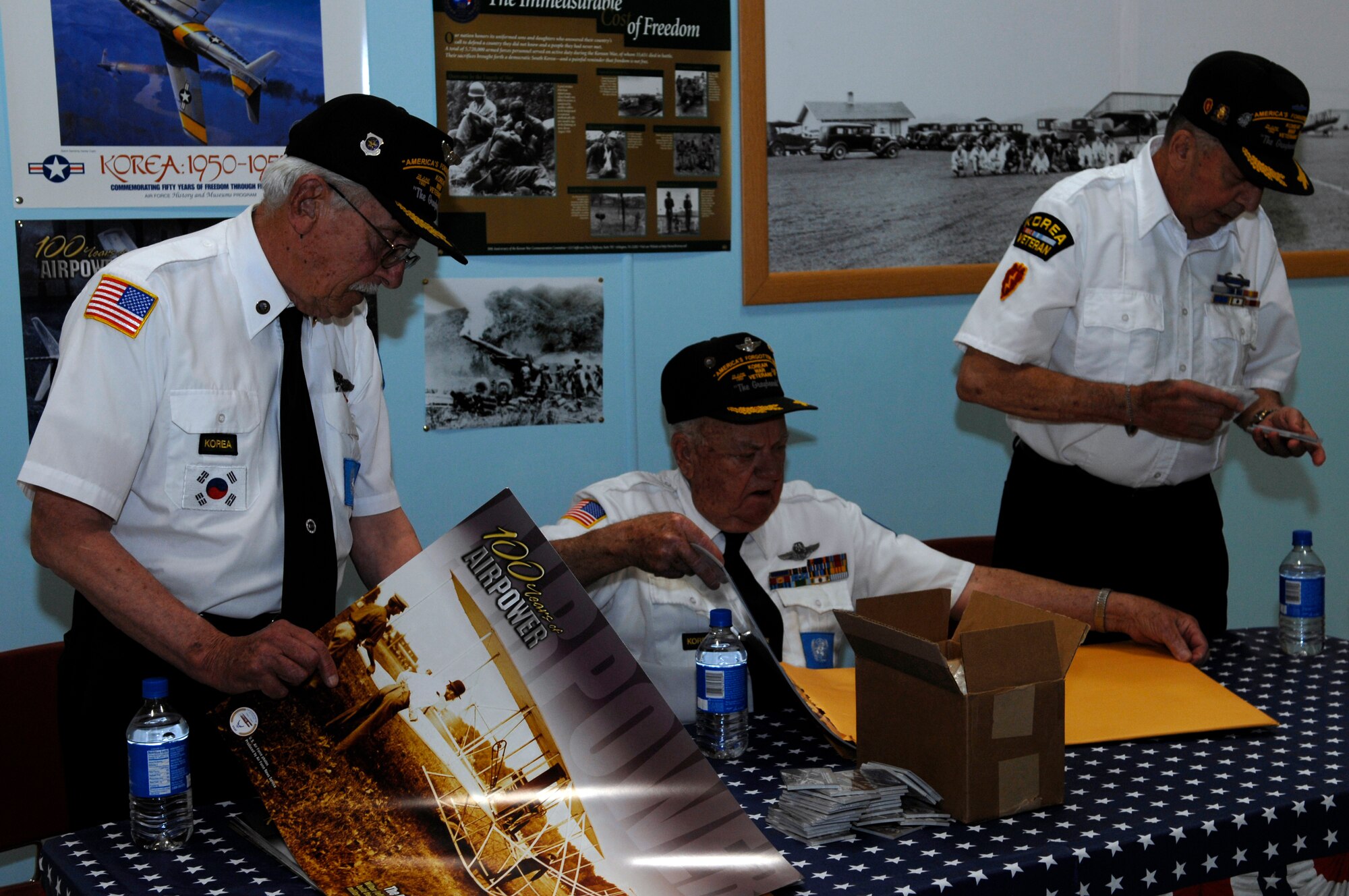(left to right) Korean War veterans Al Skidmore, retired  Lt. Col. Jerry Teachout and retired Army Master Sgt. Robert Hempel prepare to share their combat experiences for the Korean War exhibit at the South Dakota Air and Space Museum June 25. The veterans are from the local chapter of Korean War Veterans Association and added a human element to the display, which commemorates the 58th anniversary of the hostilities on the Korean peninsula. (U.S. Air Force photo/Airman Matthew Flynn)