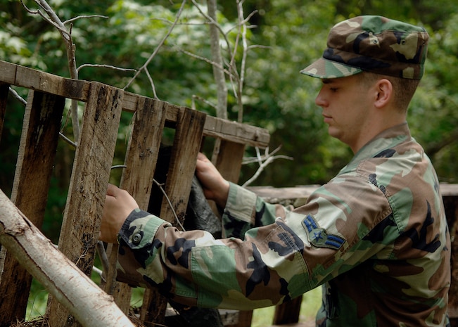 Airman 1st Class Derek Brummett builds a defensive fighting position during the mobility exercise June 23 on Charleston AFB. Airmen from Charleston AFB participated in a mobility exercise in preparation for the Headquarters Air Mobility Command operational readiness inspection in August. Airman Brummett is an entry controller with the 437th Secuirty Forces Squadron. (U.S. Air Force photo/Airman 1st Class Katie Gieratz)