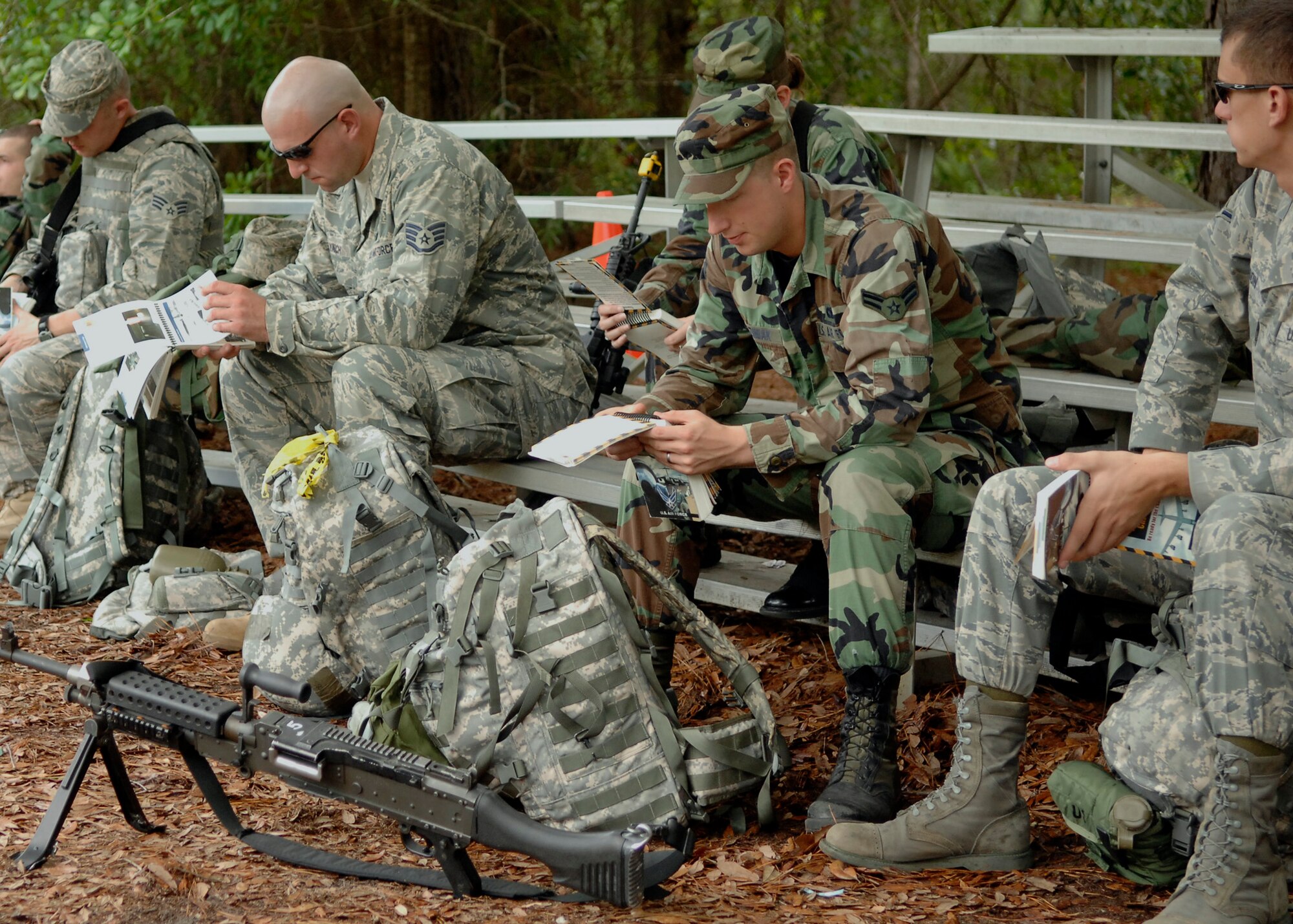 437th Security Forces Squadron Airmen study the "Airman's Manual" Air Force Manual 10-100 during the mobility exercise June 23 on Charleston AFB. Airmen from across the base are participating in a mobility exercise in preparation for the operational readiness inspection in August. (U.S. Air Force photo/Airman 1st Class Katie Gieratz)