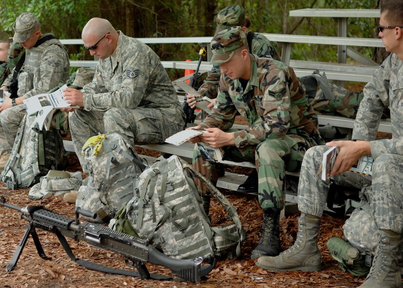 437th Security Forces Squadron Airmen study the "Airman's Manual" Air Force Manual 10-100 during the mobility exercise June 23 on Charleston AFB. Airmen from across the base are participating in a mobility exercise in preparation for the operational readiness inspection in August. (U.S. Air Force photo/Airman 1st Class Katie Gieratz)