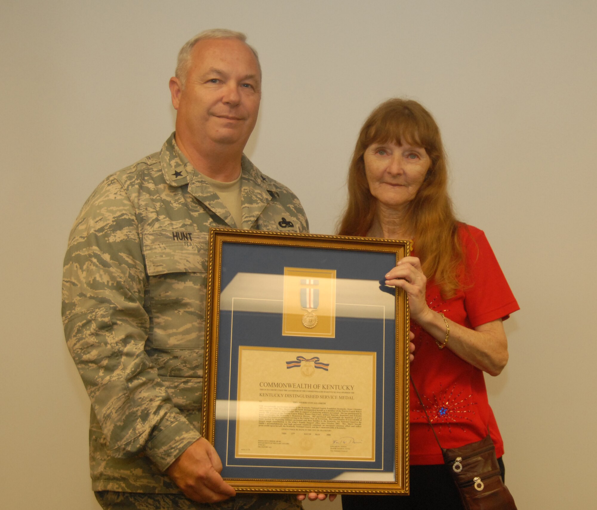 Mrs. Sherri Stovall is presented the Kentucky Distinguished Service Medal by Brig. Gen. Howard P. Hunt, III, Kentucky Air National Guard Assistant Adjutant General, for her volunteer work with the Patriot Guard riders and her unmatched contributions to the families of deployed Kentucky National Guard troops - photo by Tech. Sgt. Philip S. Speck