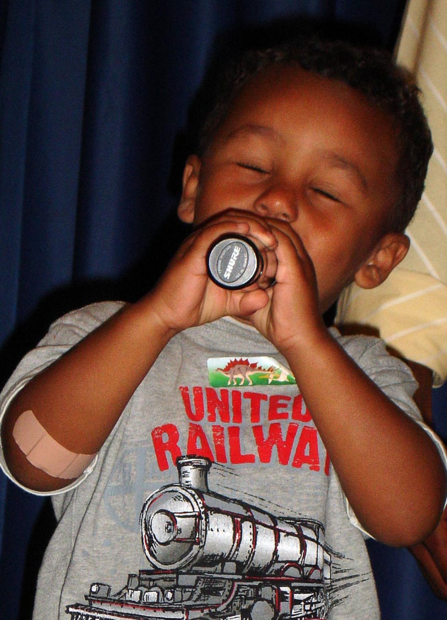 Erik Lewis Jr., makes free-style use of the microphone during the audience karaoke portion of the Focus 5/6 Star Search talent contest held June 20 at Club Vance. Erik is the son of Master Sgt. Melissa Lewis, 71st Force Support Squadron at Vance. (Photo by Staff Sgt. Ruby Barrington)