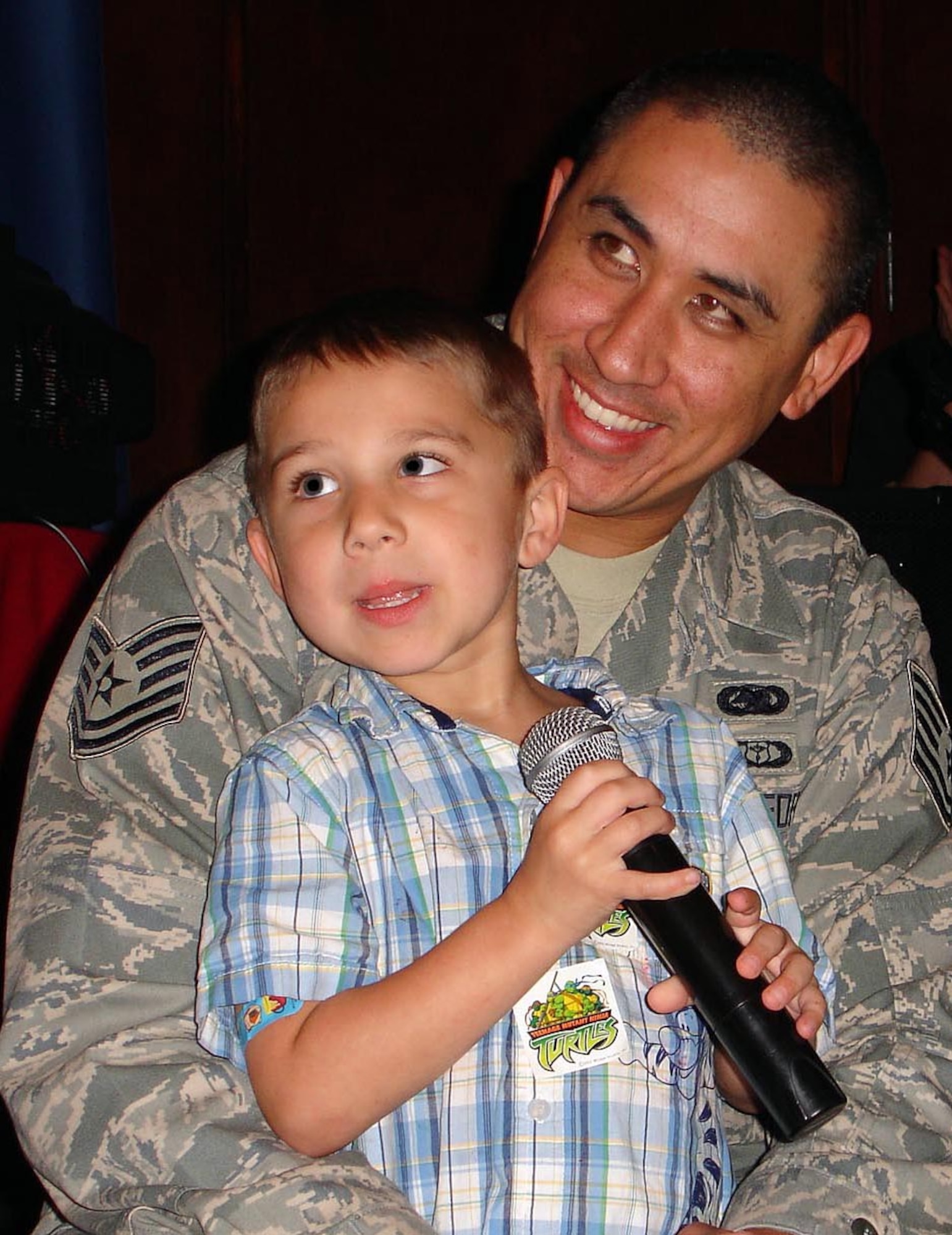 Tech Sgt. Lei Kaauamo, 71st Logistics Readiness Squadron, and his son, Kekailoa, participate in the audience karaoke part of the Focus 5/6 Star Search talent contest held June 20 at Club Vance. (Photo by Staff Sgt. Ruby Barrington)