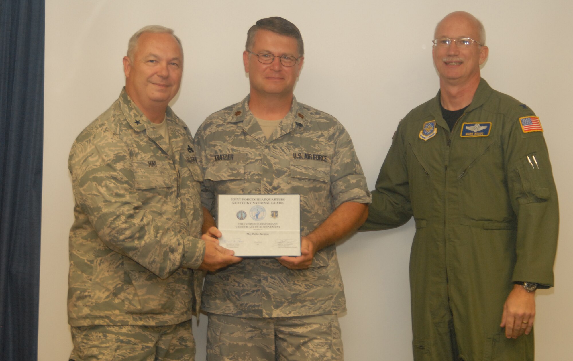 Maj. Dallas Kratzer receives the Historian’s Certificate of Achievement, presented by Brig. Gen. Howard P. Hunt, III, Kentucky Air National Guard Assistant Adjutant General, and Col. Mark R. Kraus, 123rd Airlift Wing Commander - photo by Tech. Sgt. Philip S. Speck