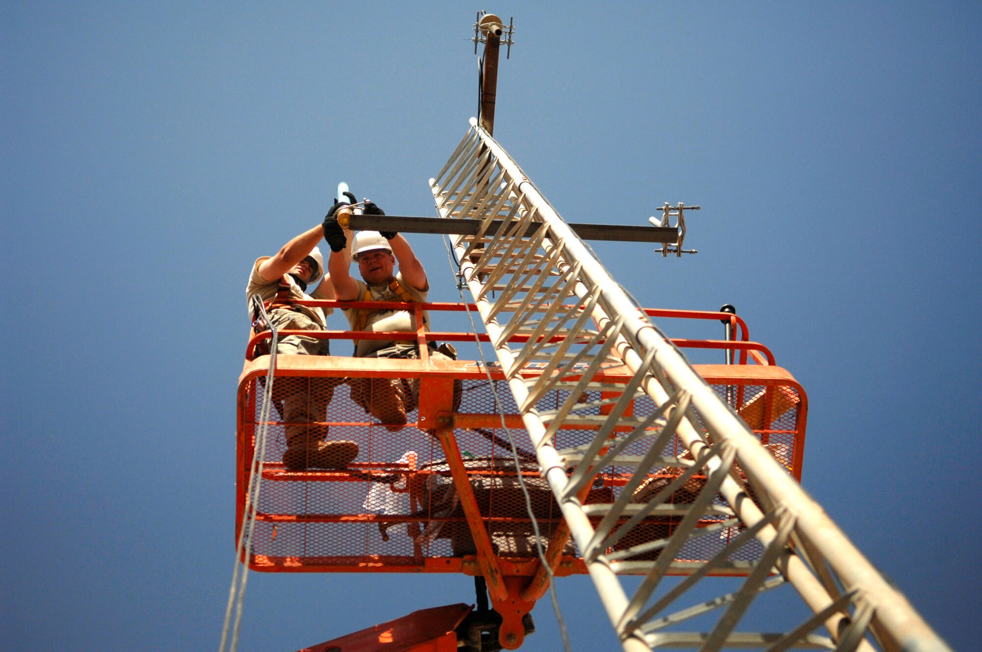 Tech. Sgt. Robert Fisher secures a high-frequency radio antenna to a communications tower June 21 at Joint Base Balad, Iraq. Tactical and land mobile radio support is critical to ground to air communications for combat air power. Sergeant Fisher is a 332nd Expeditionary Communications Squadron ground radio maintainer deployed from Youngstown Air Reserve Base, Ohio. (U.S. Air Force photo/Senior Airman Julianne Showalter) 