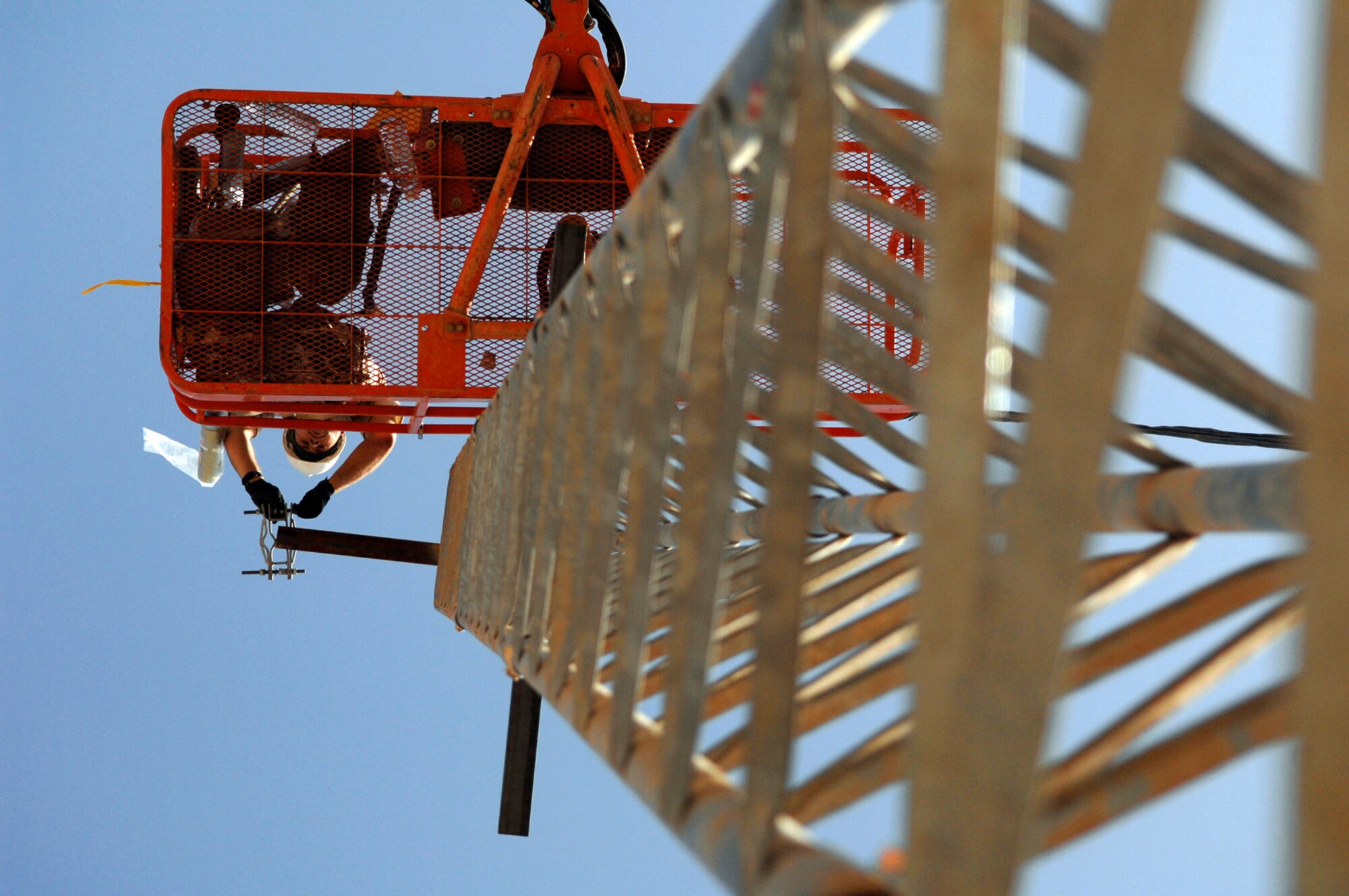 Senior Airman Paul Martin installs the support structure for a high-requency radio antenna June 21 at Joint Base Balad, Iraq. The antenna will allow greater range when using land mobile radios which enhances the capabilities for ground-to-air operations. Airman Martin is a 332nd Expeditionary Communications Squadron ground radio maintainer deployed from Yokota Air Base, Japan. (U.S. Air Force photo/Senior Airman Julianne Showalter) 