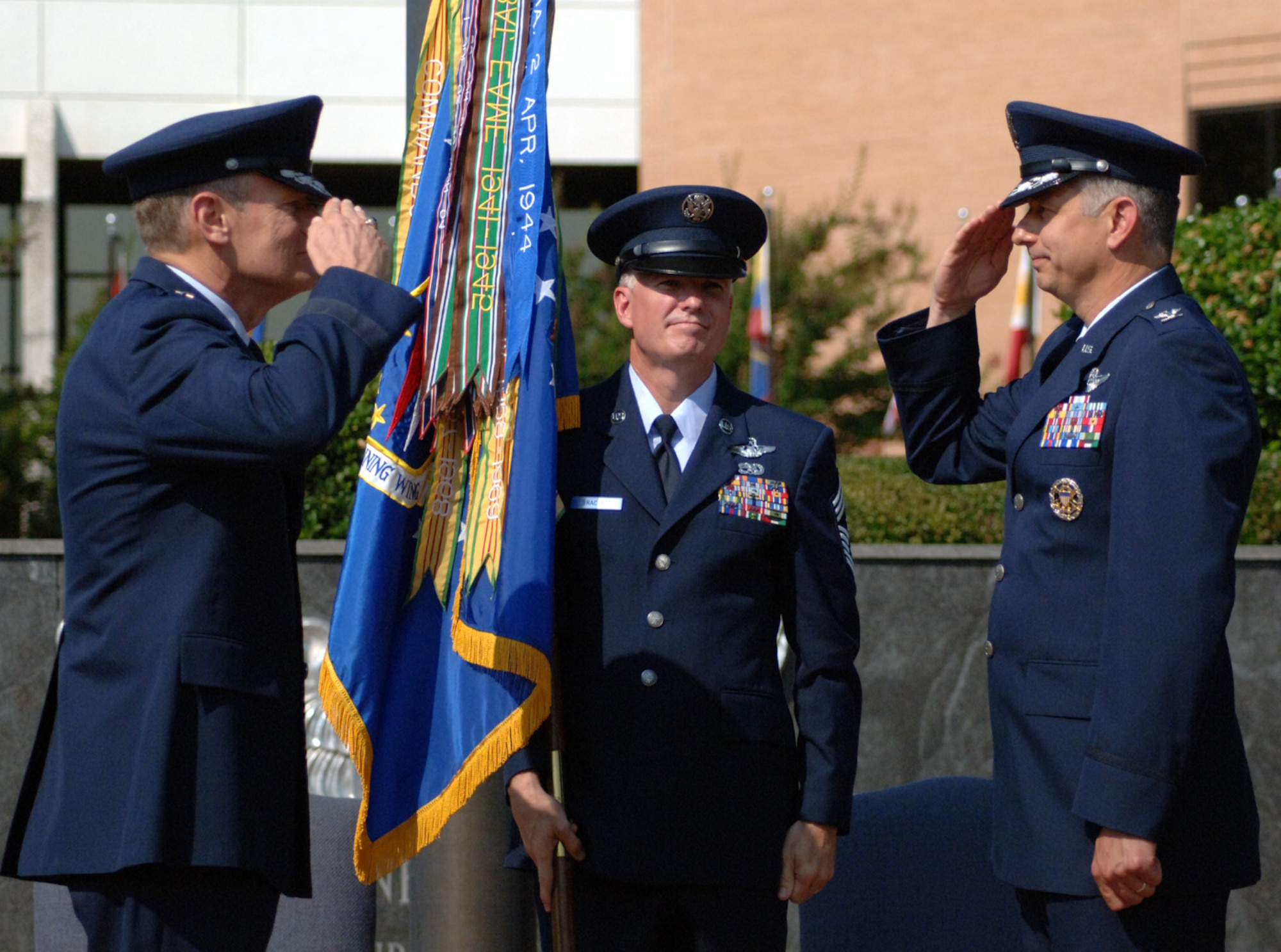 Colonel Roger Watkins salutes Maj. Gen. Irving Halter, 19th Air Force commander, after assuming command of the 14th Flying Training Wing at a ceremony held in Smith Plaza Wednesday. Also pictured is Chief Master Sgt. Richard Brackett, 14th FTW Command Chief Master Sergeant, who presented the flag to General Halter who then presented it to Colonel Watkins. (U.S. Air Force photo by Airman Josh Harbin)