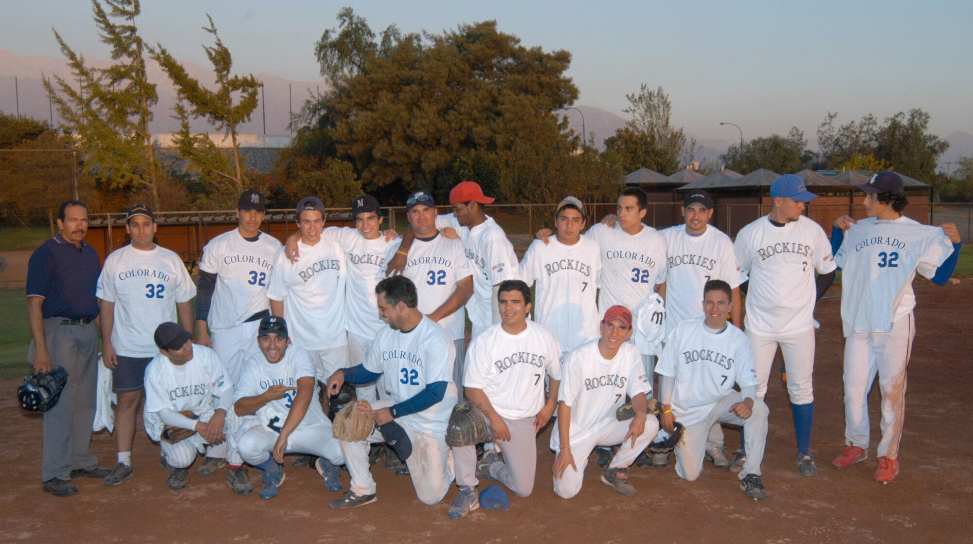 The Santiago Metros semi-pro baseball team poses proudly in their new Colorado Rockies tee shirts, after trouncing the visiting U.S. Airmen 8 to 5 in a friendly display of baseball diplomacy. Airmen stationed at Davis-Monthan Air Force Base and 12th Air Force (Air Forces Southern) worked with the Rockies to get donations of tee shirts, backpacks and hats for not only the Chilean team but the local children in Santiago. The Airmen were taking part in FIDAE 2008, one of the largest air and trade shows. (U.S. Air Force photo/Master Sgt. Jason Tudor).