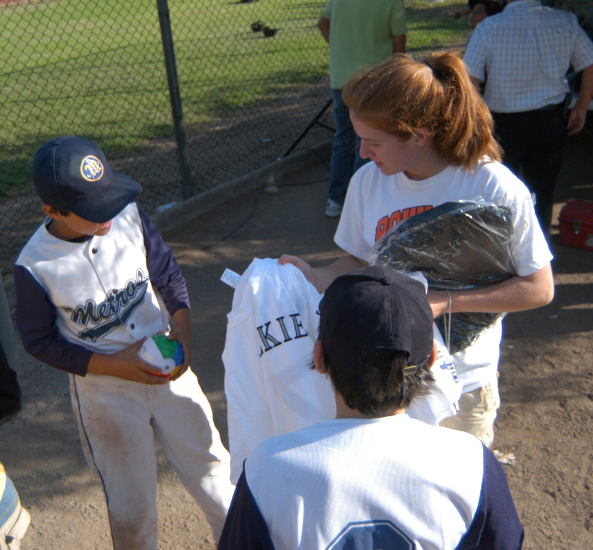 A U.S. Airman gives out tee shirts and backpacks, donated by the Colorado Rockies professional baseball team, to the members of the Santiago Metros semi-pro team. The Airmen were in Chile for FIDAE 2008, one of the largest air and trade shows in the world, as well as Exercise Newen. U.S. Southern Command will continue the cameraderie later this year as they launch a baseball diplomacy tour. (U.S. Air Force photo/Master Sgt. Jason Tudor).                               