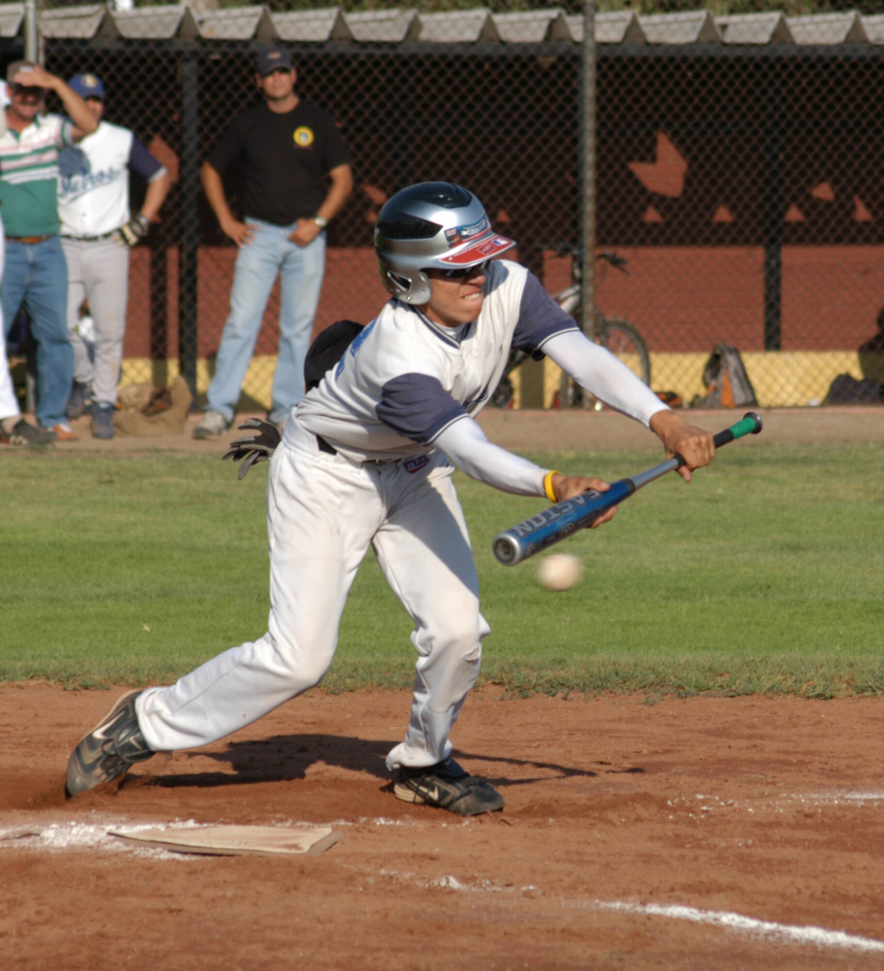 A player for the Santiago Metros semi-pro baseball team gets ready to bunt and take off for first base during a game played against U.S. Airmen visiting Chile. The Airmen were in town for FIDAE 2008, one of the largest air and trade shows as well as Exercise Newen 2008, participating with the Chilean Air Force. Airmen from Davis-Monthan Air Force Base, Ariz., and 12th Air Force (Air Forces Southern) brought gifts of tee shirts, backpacks and hats, donated by the Colorado Rockies professional baseball team, to the Santiago players as well as the local children. (U.S. Air Force photo/Master Sgt. Jason Tudor).
