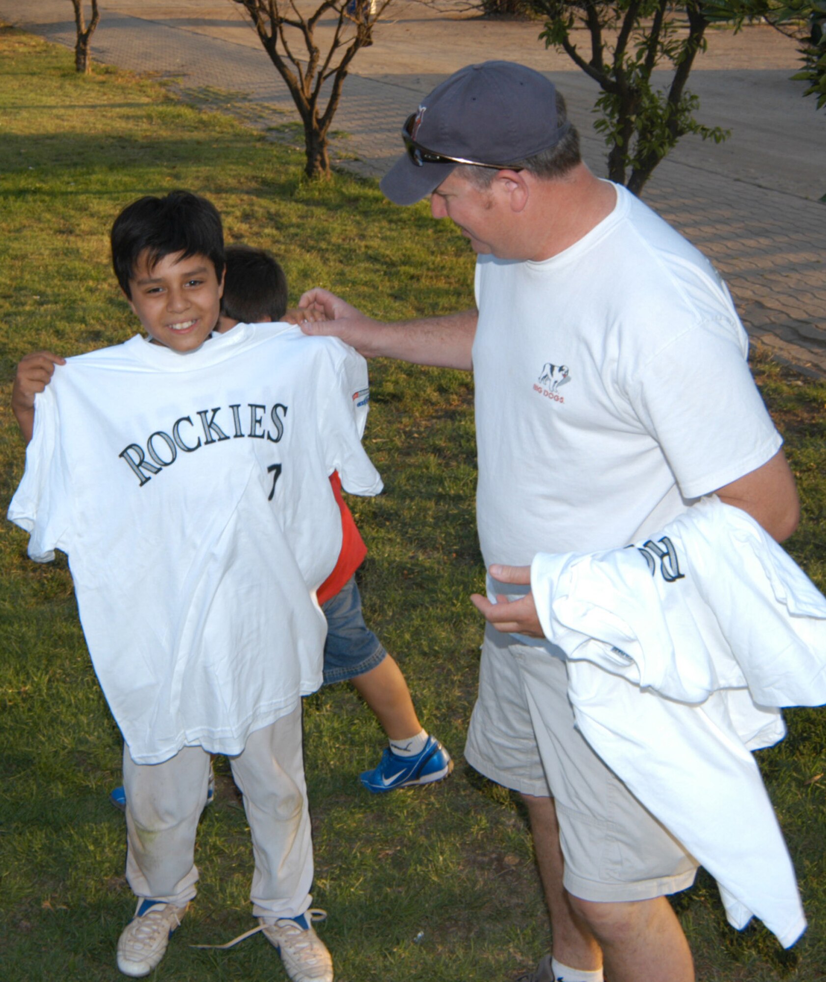 Airmen assigned to Davis-Monthan Air Force Base, Ariz., hand out Colorado Rockies tee shirts and backpacks to the children of Santiago, Chile. The Airmen and U.S. Air Force aircraft were part of FIDAE 2008, one of the largest combined air and trade shows, and for Exercise Newen 2008. The exercise builds the partnership between the U.S. and Chilean militaries. U.S. Airmen got to practice baseball diplomacy as well, in a friendly game that matched them up to the Santiago Metros, a 19-and-under squad filled with semi-pros. The Colorado Rockies donated items for the children, and the Air Force gave away memorabilia, as well as the game, to their opponents. (U.S. Air Force photo/Master Sgt. Jason Tudor)                                