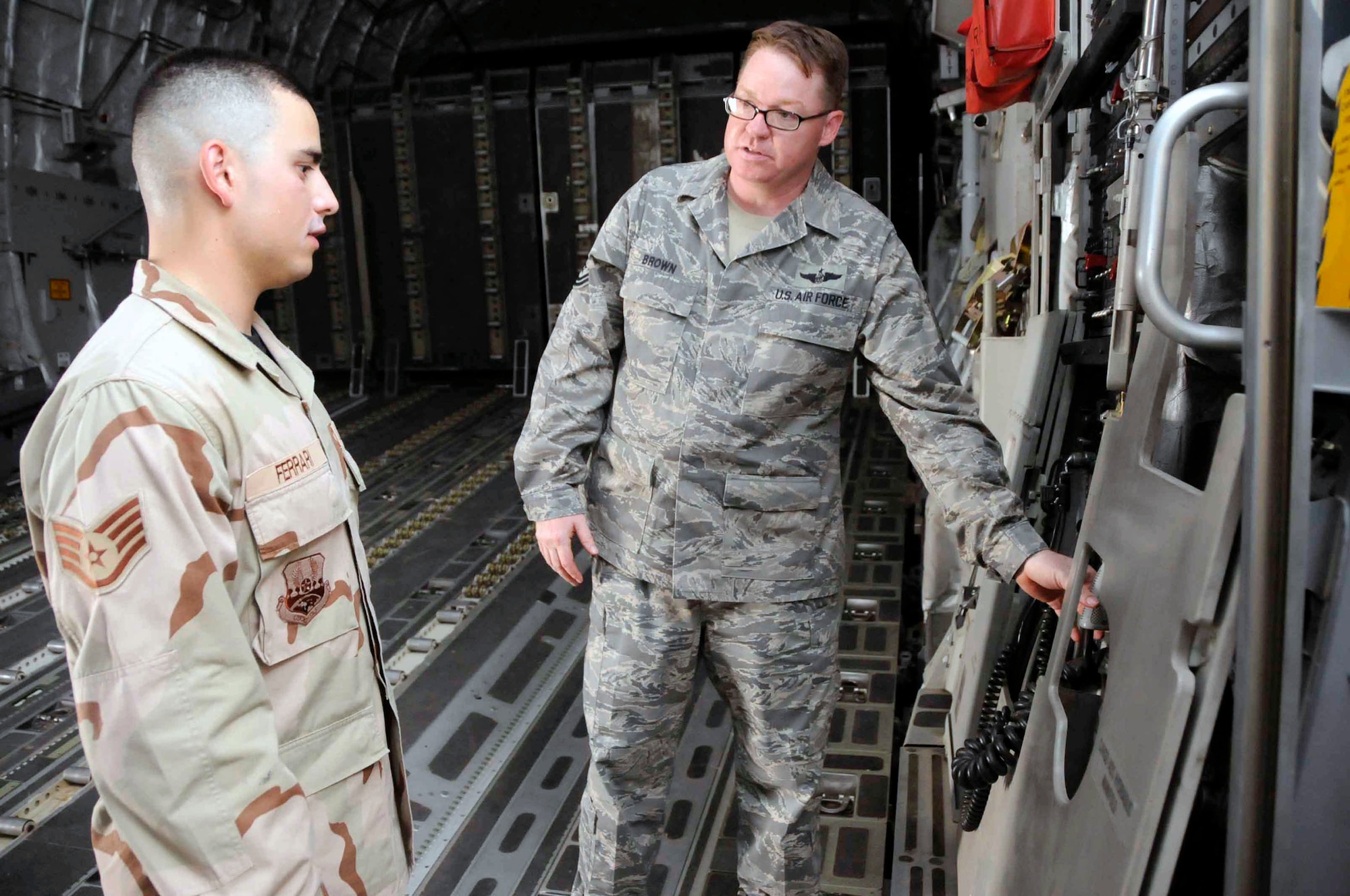 Tech. Sgt. Robert Barton shows Staff Sgt. Jacob Pennell some radiology procedures June 24 in Southwest Asia. The Airmen are taking part in a mentor/shadow program designed to help younger Airmen who are deployed make major career decisions while far away from career advisors and other personnel specifically trained to help in those areas. Sergeant Barton is with the 379th Expeditionary Medical Group and Sergeant Pennell is with the 379th Expeditionary Maintenance Squadron. (U.S. Air Force photo/Senior Airman Domonique Simmons) 