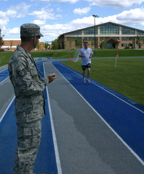 Tech. Sgt. Brian Pusey, a fitness monitor for the 419th Maintenance Squadron, calls out the time to Master Sgt. Mark Howell, from the MXS. Sergeant Howell completed his annual fitness test in the Air Force’s Fit to Fight program. (U.S. Air Force photo/Staff Sgt. Kyle Brasier)