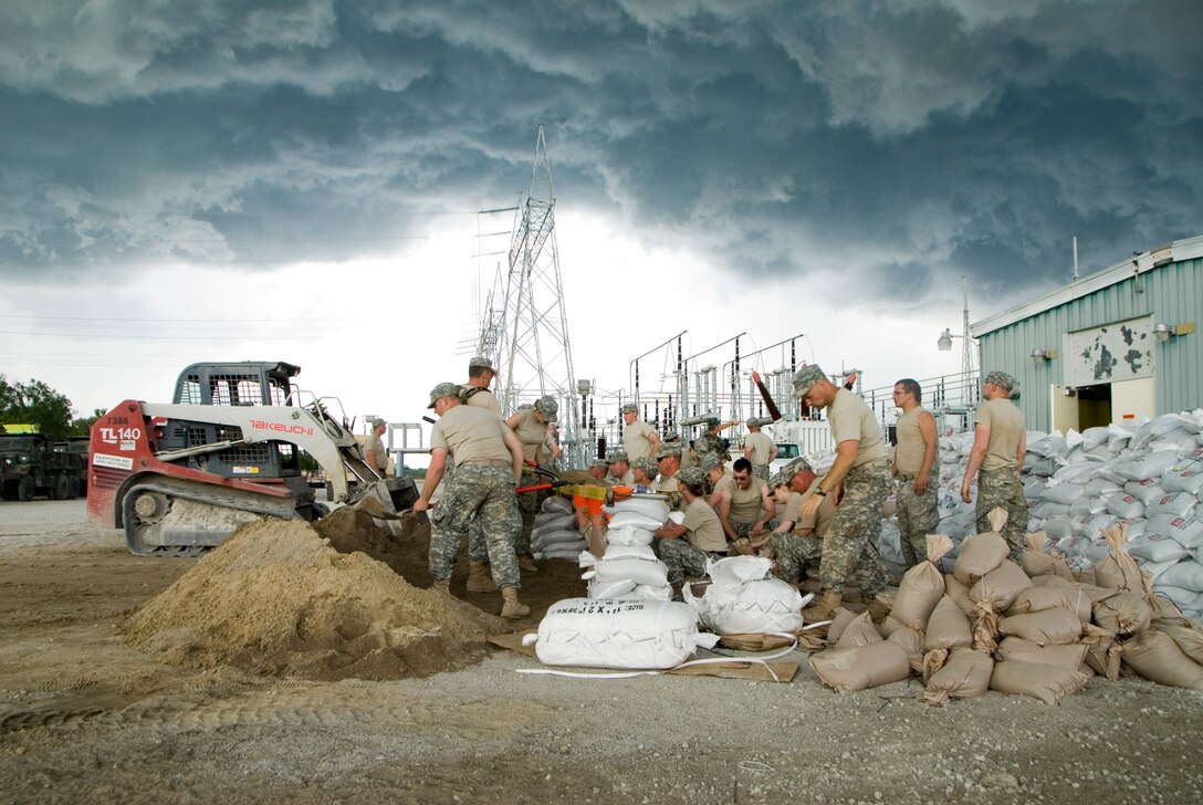 June 14, 2008, Iowa Army National Guard Soldiers are working hard to complete a seven foot sandbagged levy in order to protect an electrical generator from the rising floodwaters. There are approximately 80 soldiers sandbagging at the generator plant, including some with the horizontal engineers, medics and even the 34th Army Band out of Fairfield, Iowa.
Official Air Force photo by: Staff Sgt. Oscar M. Sanchez-Alvarez


