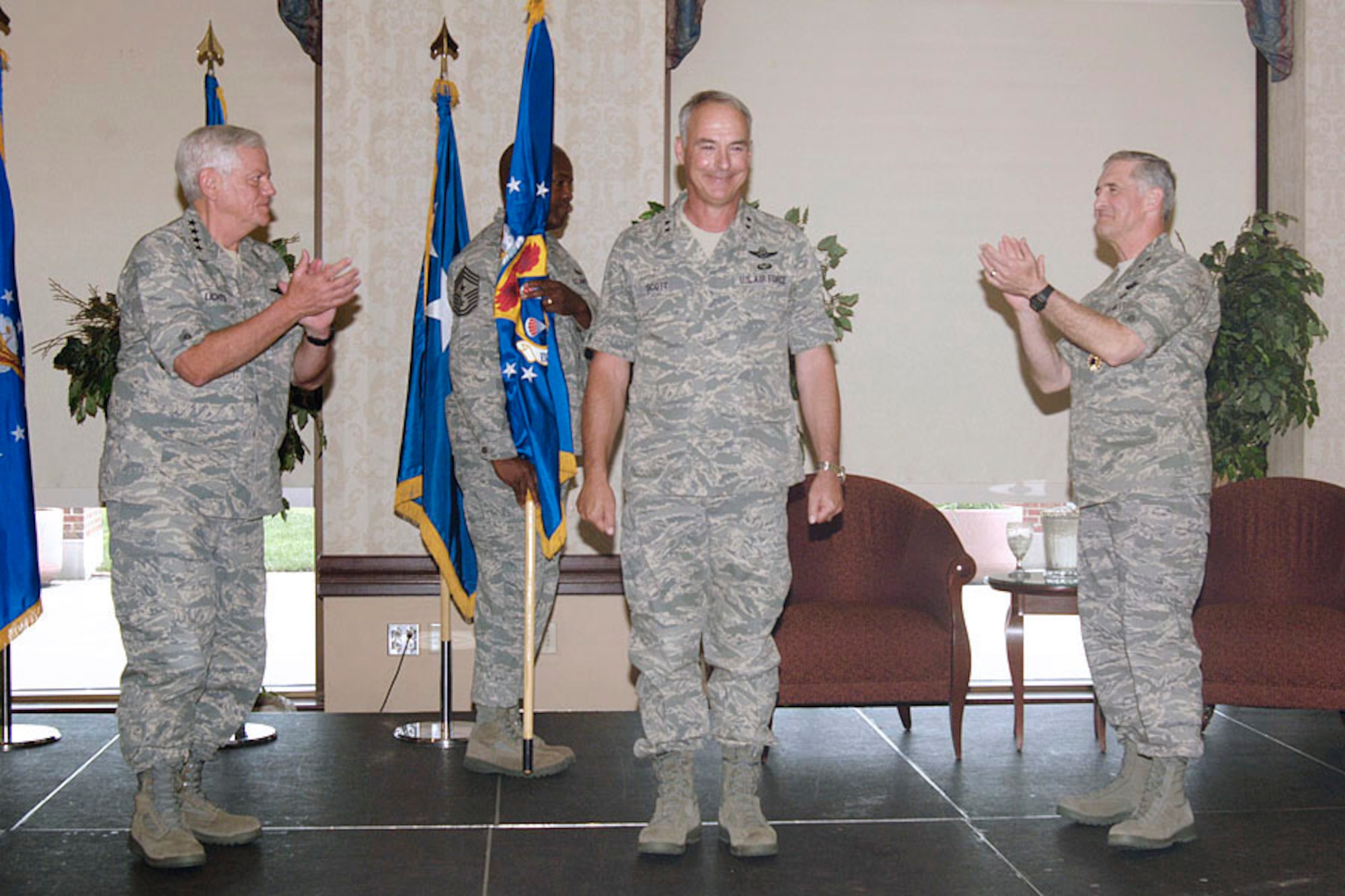 Gen. Arthur Lichte, Air Mobility Command commander (left), and Maj. Gen. James Hawkins, former 18th Air Force commander (right), congratulate Maj. Gen. Winfield Scott III for being named the new 18 AF commander during the change of command ceremony at the Scott Club  June 24. (U.S. Air Force photo/Senior Airman Jonathan Lovelady)