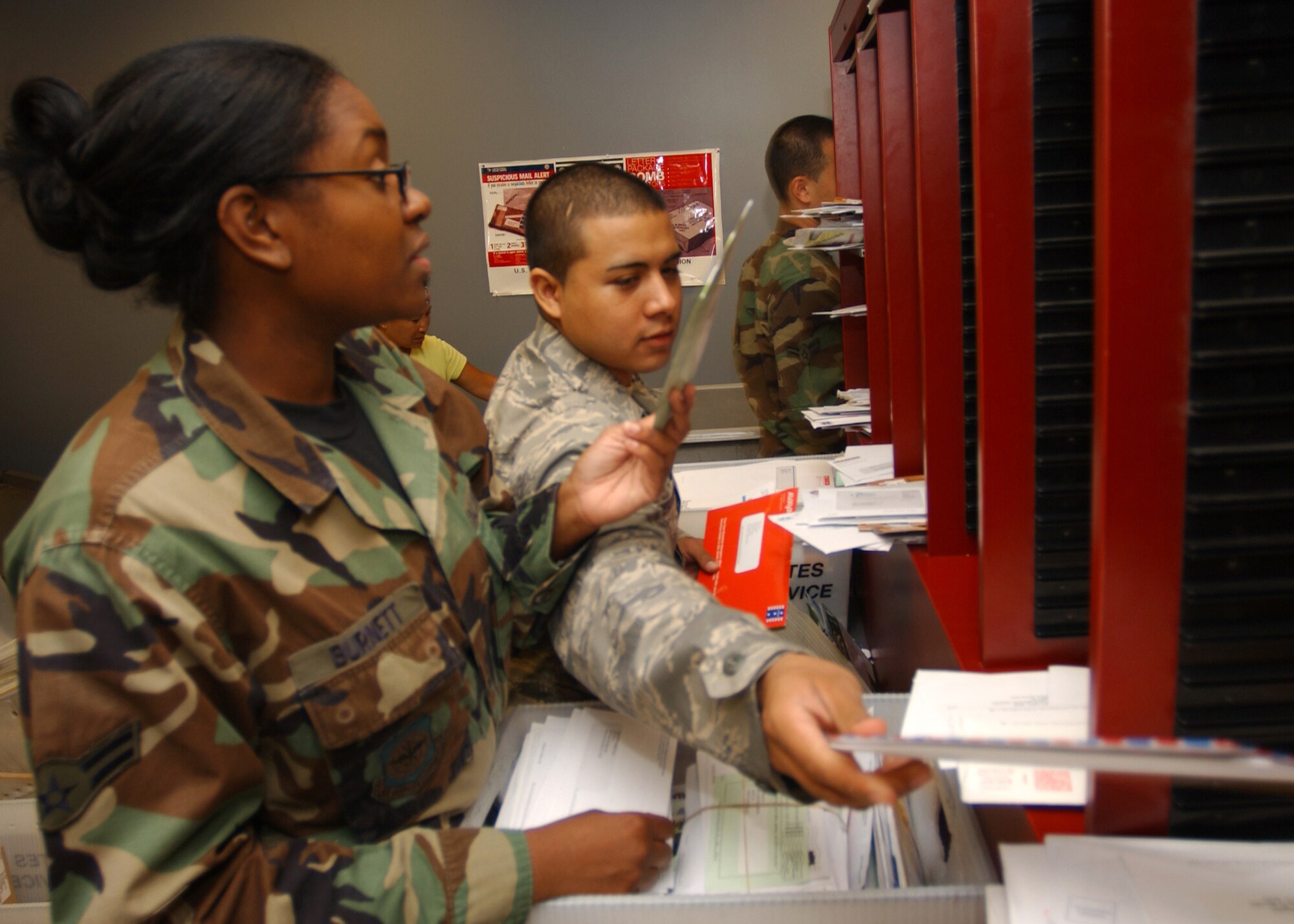 SCOTT AIR FORCE BASE, Ill. -- Airmen 1st Class Dareena Burnett and Aldo Mazariegos-Veleon perform the initial sort after screening everything for explosive, chemical and biological threats.                              
(US Air Force photo/Master Sgt. Brian Davidson)