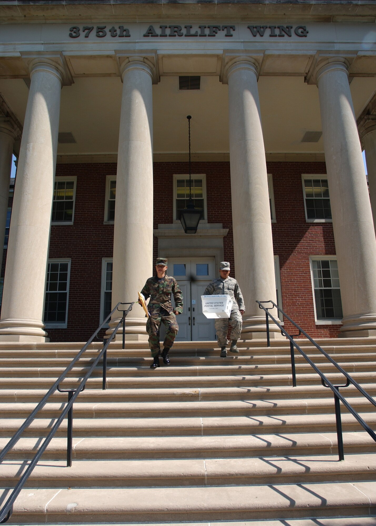 SCOTT AIR FORCE BASE, Ill. -- Airmen 1st Class DeHui Yu and Aldo Mazariegos-Veleon leave the 375th Airlift Wing headquarters building after delivering and picking up official mail.
(US Air Force photo/Master Sgt. Brian Davidson)