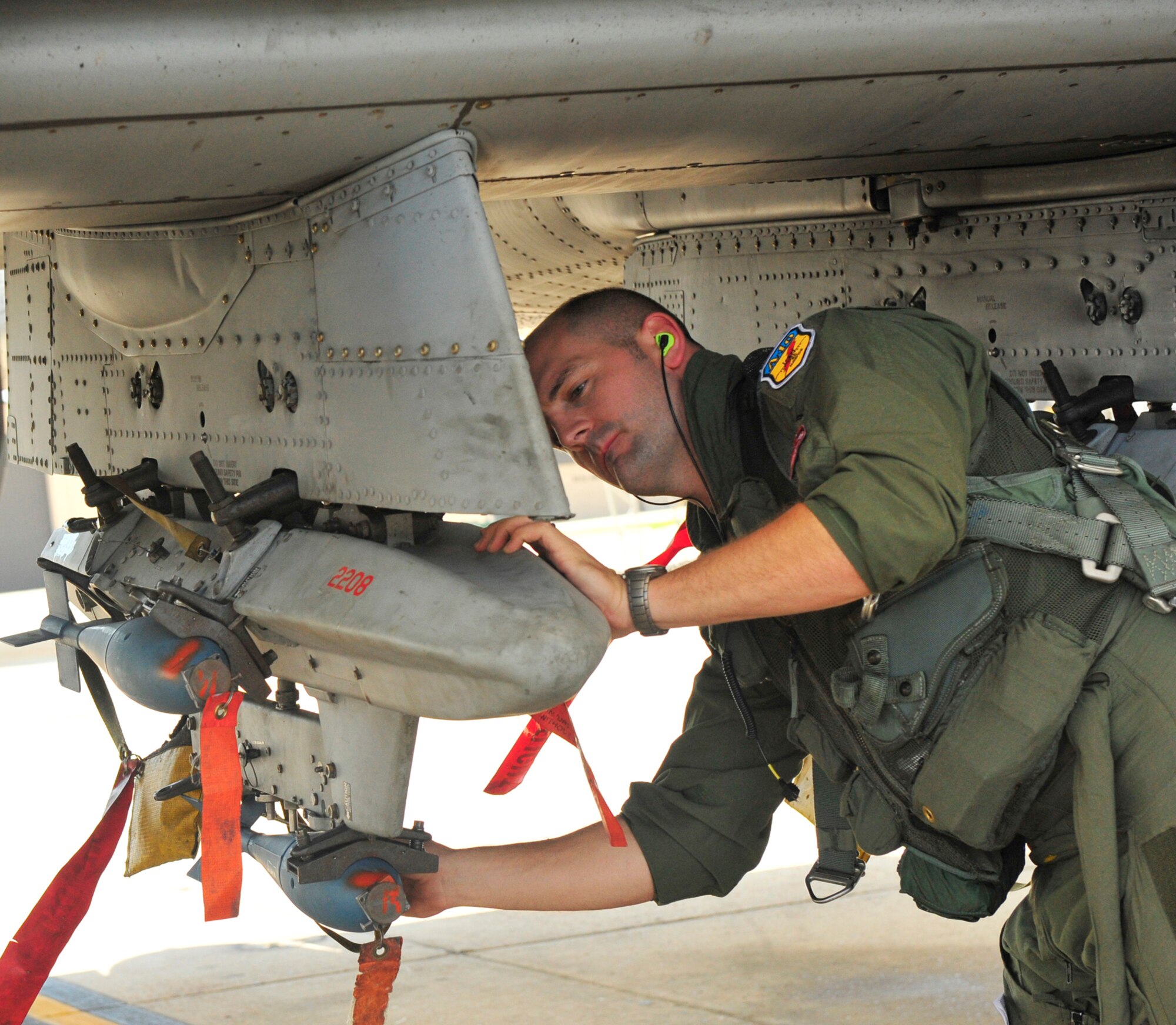 Capt. LaRue Russell inspects the triple ejector rack prior to taking flight June 18 at Moody Air Force Base, Ga. The flight is part of an Air Force-wide initiative designed to integrate reservists, guardsmen and civilians with active-duty Airmen. Captain Russell is a reservists and the 442nd Fighter Wing Det. 1 director of training. (U.S. Air Force photo/Senior Airman Schelli Jones)