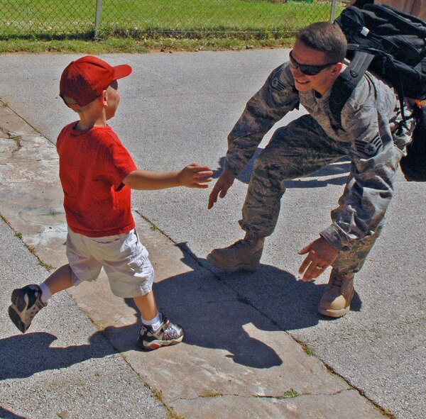 DYESS AIR FORCE BASE, Texas -- Staff Sgt Samuel McCurley, 317th Aircraft Maintenance Squadron, gets a big welcome home hug from his son after a four-month rotation to Southwest Asia, June 18.  More than 300 Airmen deployed from the 317th Airlift Group and performed operations in support of Operations Enduring/Iraqi Freedom.  Some members also supported operations in the Horn of Africa.  (U.S. Air Force photo by Staff Sergeant Connor Estes).      