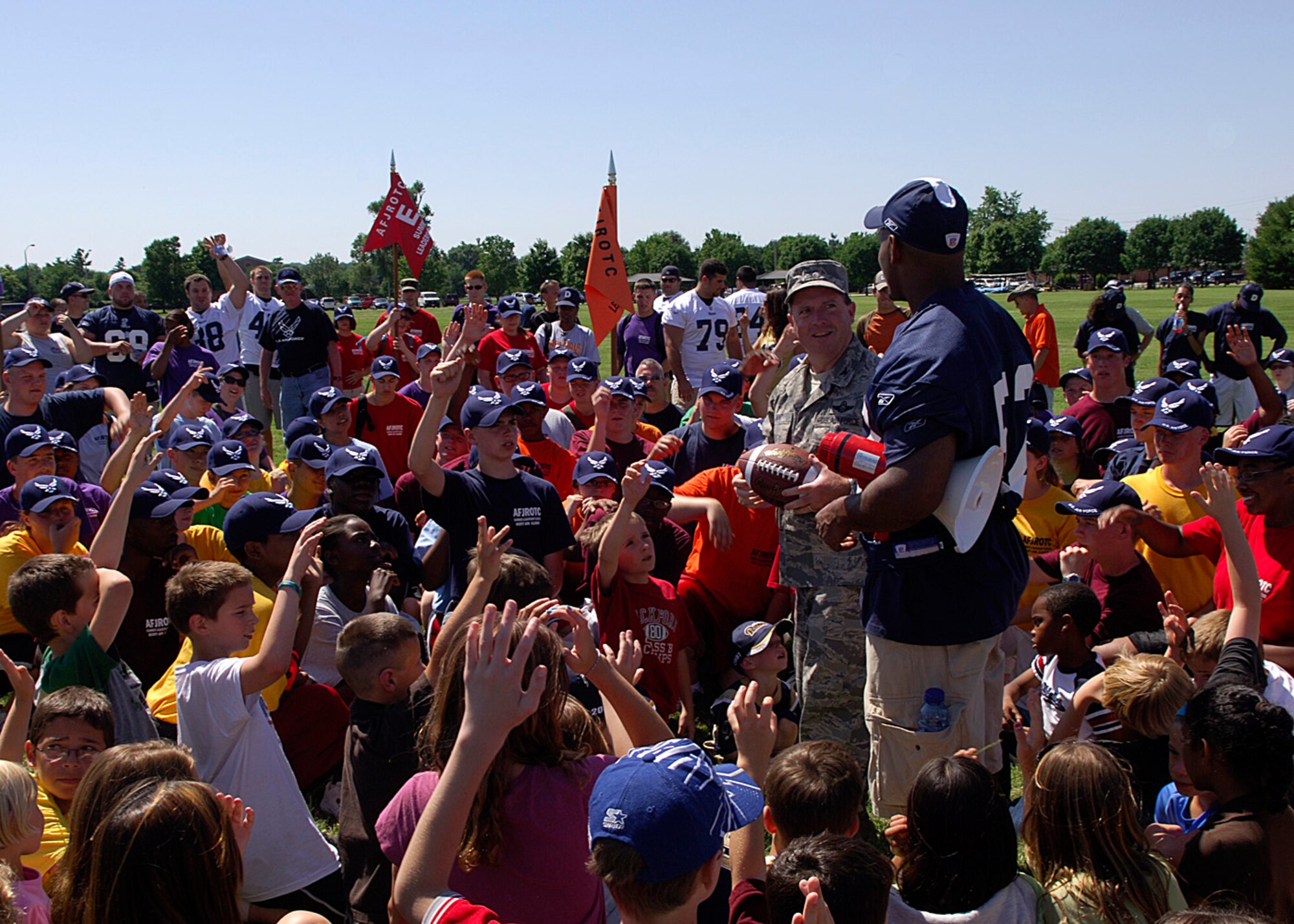 SCOTT AIR FORCE BASE, Ill. -- Col. Al Hunt, 375th Airlift Wing commander and St. Louis Rams’ player Chris Draft address members of Joint Total Force Scott, dependents and cadets from the Air Force Junior Reserve Officer Training Course program after completing an afternoon of football drills and other events. 
(US Air Force photo/Airman 1st Class Wesley Farnsworth)