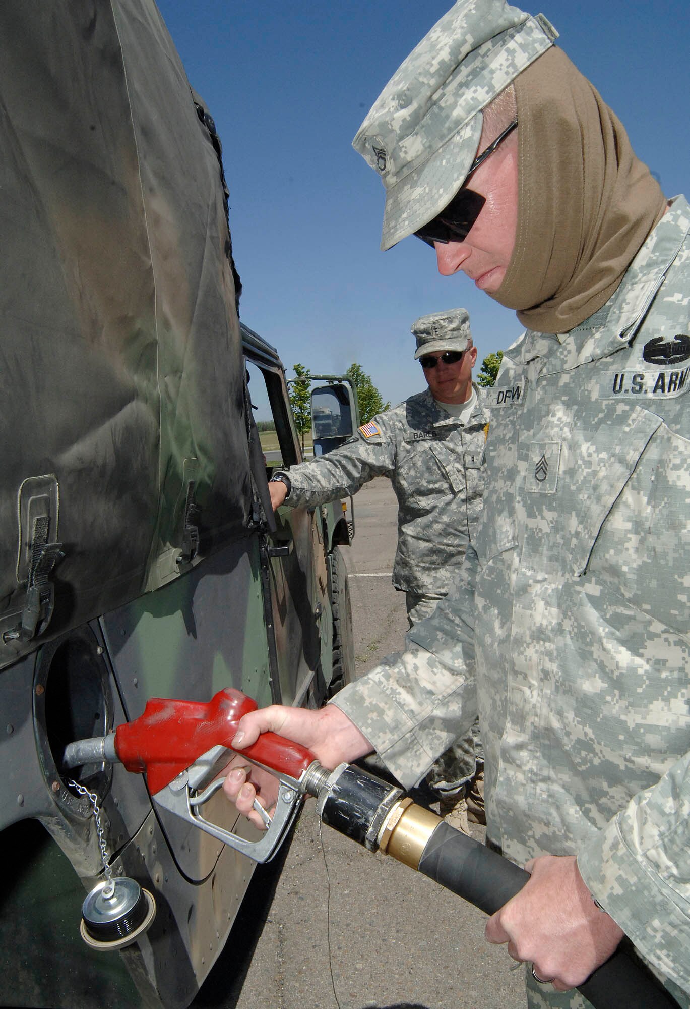 FAIRCHILD AIR FORCE BASE, Wash. – Army Staff Sgt. Joseph Drews, 353rd Transportation Company, Buffalo, Minn., refuels his truck as Chief Warrant Officer Erik Bares, 353rd TC, looks on, during a joint-training exercise here June 17. The 353rd TC participated in a five-day exercise which led a convoy of 39 vehicles starting in Minnesota and ending in Washington. (U.S. Air Force photo / Staff Sgt. JT May III)


