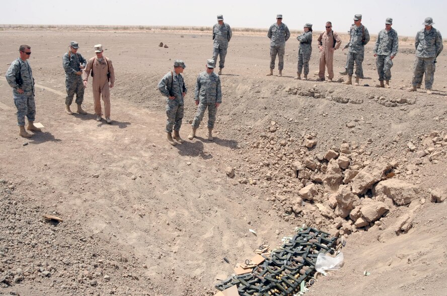 ALI BASE, Iraq -- Tech. Sgt. Raymond Lunbeck Jr., explosive ordnance disposal craftsman, briefs Brig. Gen. Burton Field, the 332nd Air Expeditionary Wing commander, at the detonation site here June 25. The explosive ordnance disposal team detonated approximately 350 pounds of explosives recovered from a weapons cache in the local area. Sergeant Lunbeck is deployed to the 407th Expeditionary Civil Engineer Squadron from Dyess Air Force Base, Texas. (U.S. Air Force photo/Tech. Sgt. Sabrina Johnson)