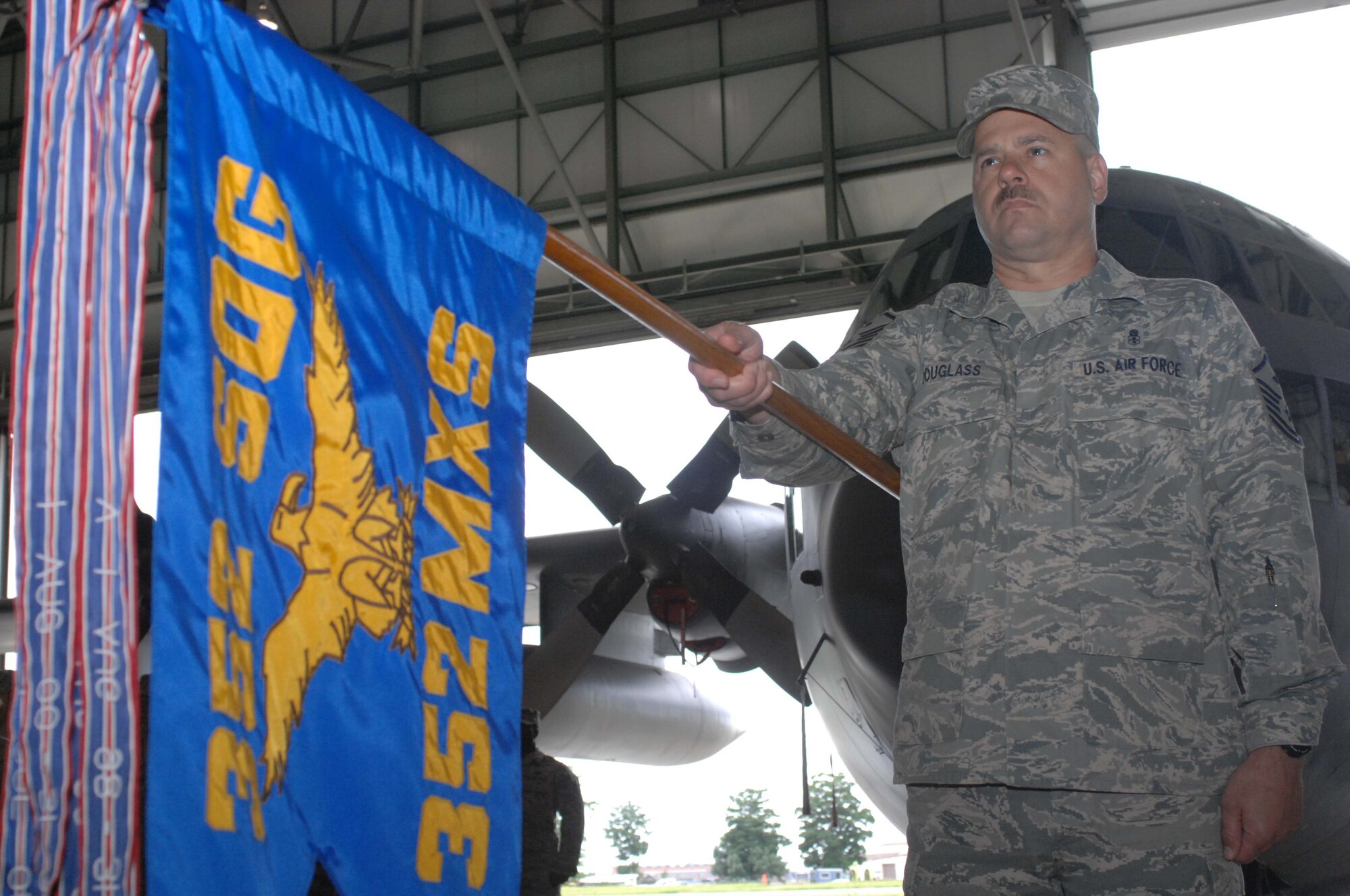 Master Sgt. Glenn Douglass, 352nd Maintenance Squadron first Sergeant, presents the 352nd MXS guidon in the salute position at the playing of the British and American National Anthems during the squadron's Assumption of Command Ceremony for Lieutenant Colonel Dean R. Judge June 12. (U.S. Air Force photo by Airman 1st Class Brad Smith)
