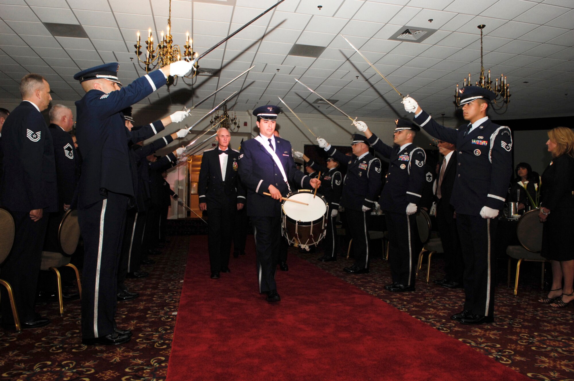 HANSCOM AFB, Mass. – Retired Lt. Gen. Charles L. Johnson II, former Electronic Systems Center commander, is escorted past the Honor Guard into the Minuteman Club at the beginning of the AFMC Order of the Sword ceremony June 20. The Order of the Sword is the highest honor that Air Force noncommissioned officers can bestow upon an individual. (U.S. Air Force photo by Mark Wyatt.)